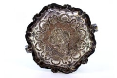 Shell-shaped silver ashtray with armorial reliefs and two cigarette holders