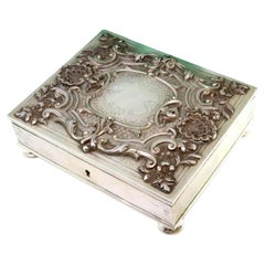 Shell-shaped silver jewelry box with reliefs, monogram and velvet interior