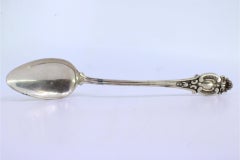 Shell-shaped silver rice/serving spoon with reliefs and grooved handle