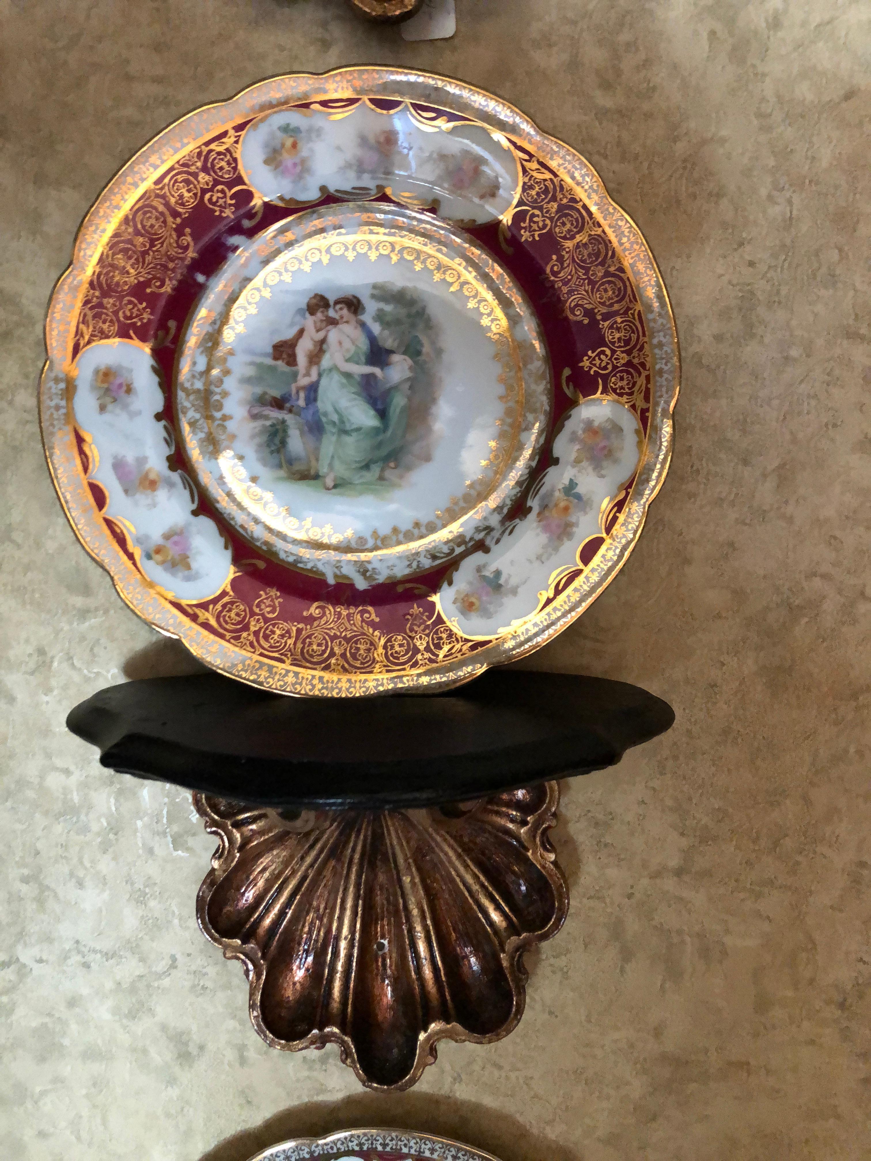 These shell style plate holder/shelves are made of plaster. They are carefully crafted and hand finished in my studio. The shell has gold leaf foil applied over a red base. The gold leaf is then given a brownish stain for an antique appearance. The