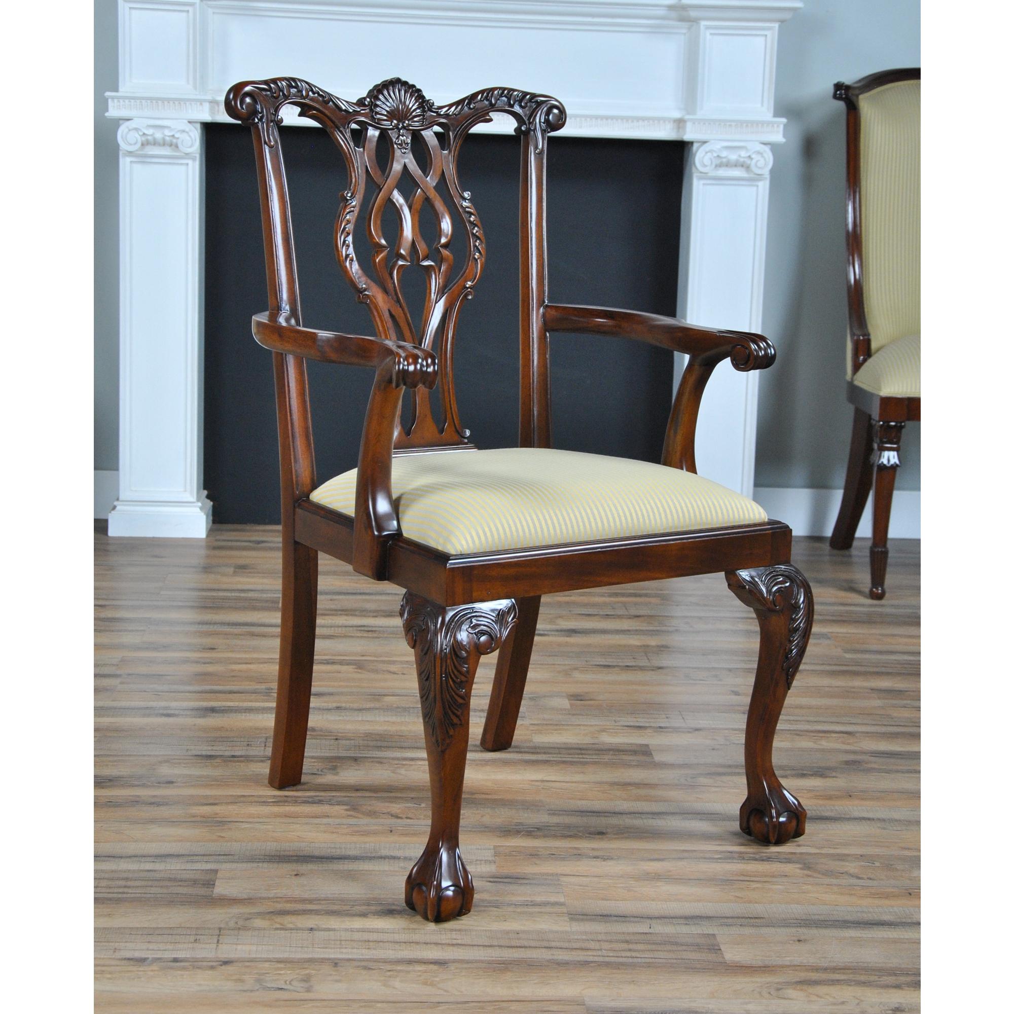 The set of 10 Shellback Mahogany Dining Chairs, are a high end solid mahogany Chippendale style chair with a serpentine top crest rail that boasts a carved clam shell and scrolled acanthus foliage carvings above a similarly carved and pierced back