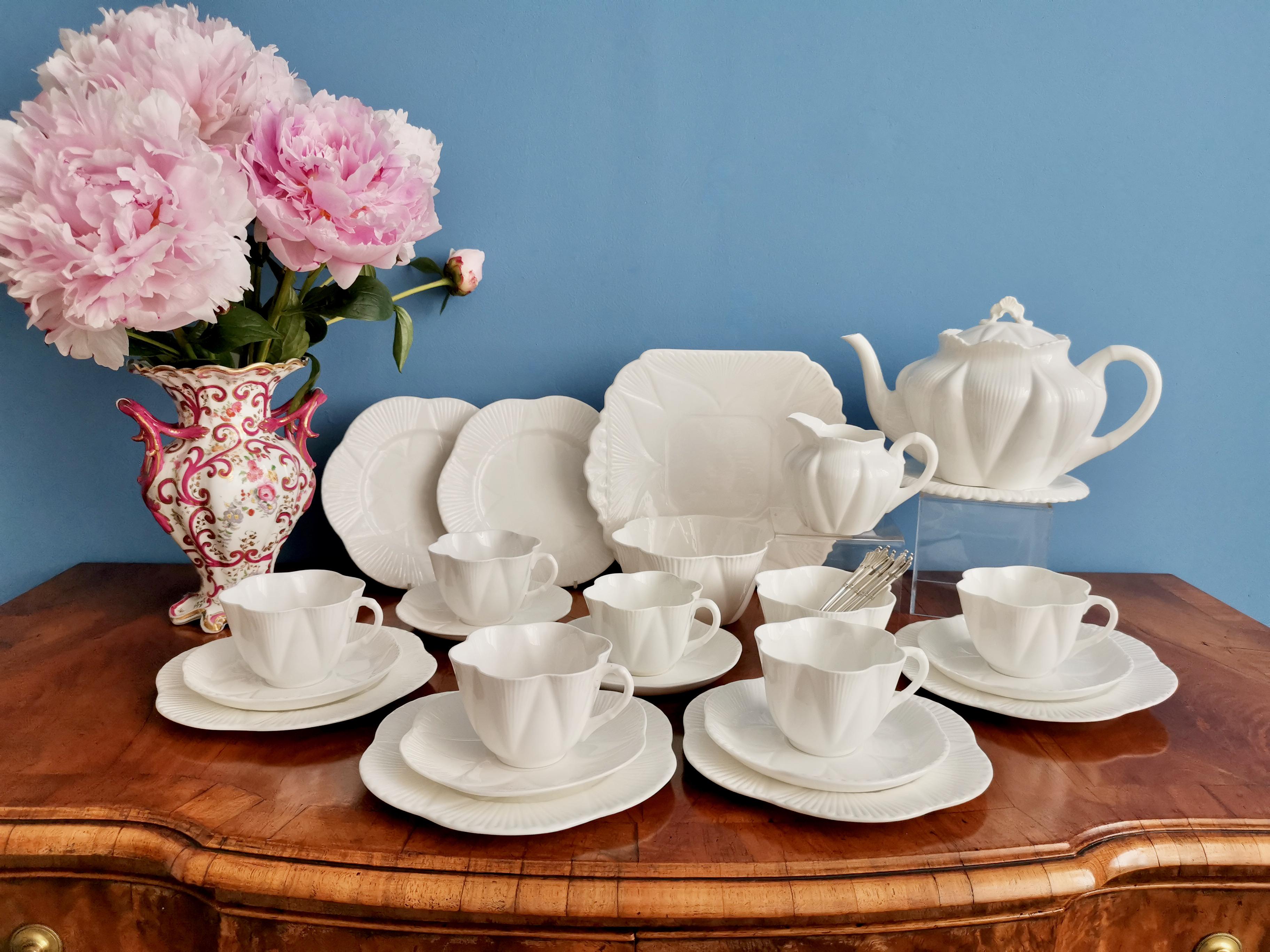 This is a beautiful full tea service serving six, made by Shelley. The items are from different periods, all between 1910 and 1966. The service is made in the popular 