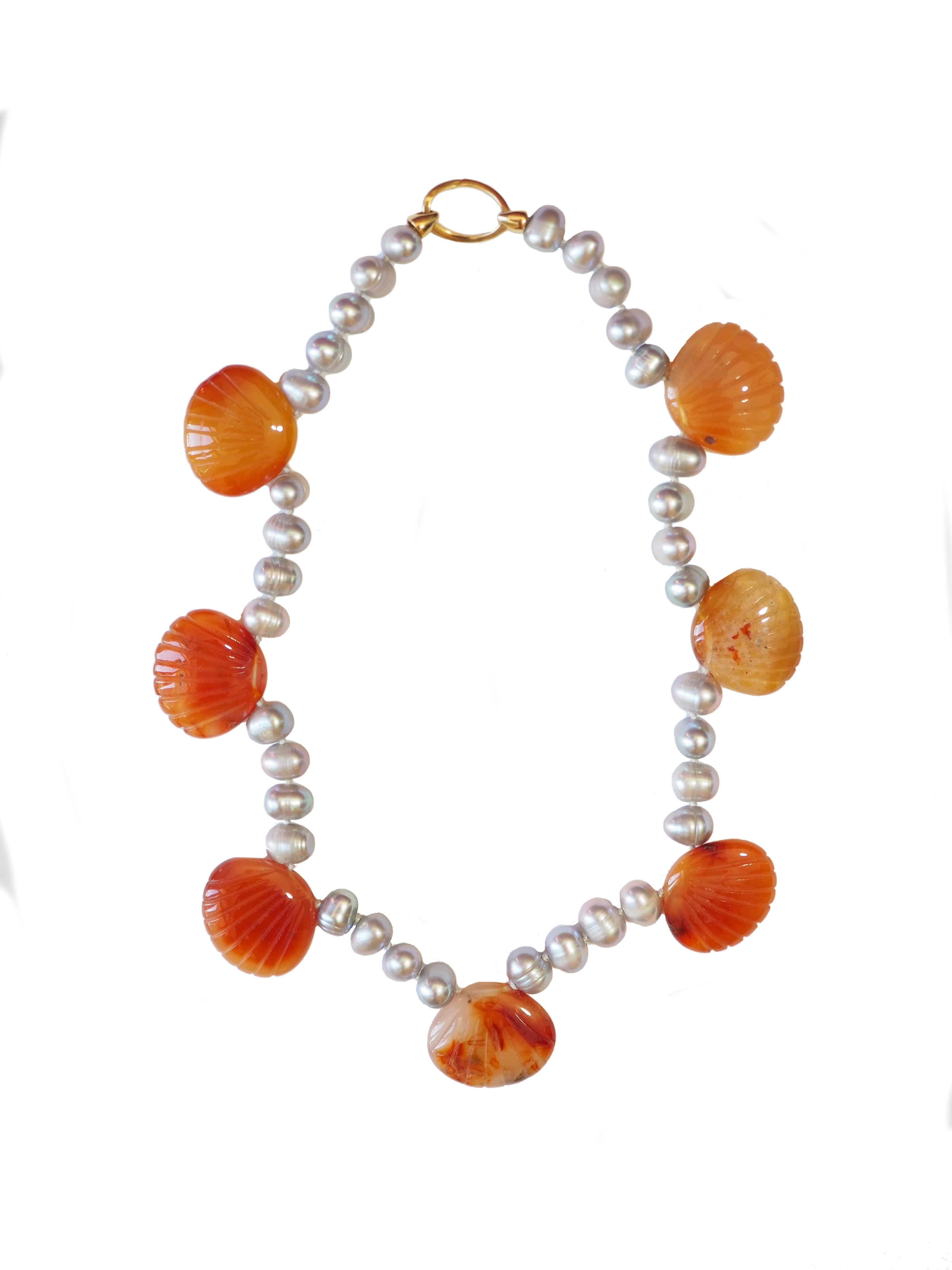 necklace with grey fresh water pearls, carved carnelian shells gold total length 45 cm  weight 114,6 gr.
Unique pieces .