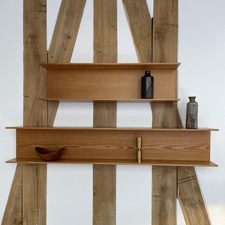 Set of two pine shelves by Walter Wirz for Wilhem Renz in Germany. These two shelves with their practical, functional and elegant design can hold twice as many things as a conventional shelf. In addition, the lines of the design bring out the grain