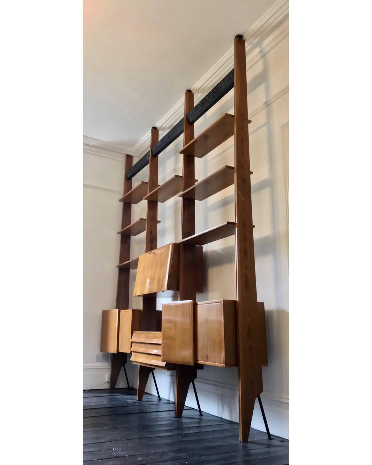 Modular shelving system or room divider attributed to Dassi of Milan, Italy 1950s.

A sophisticated design with lots of interesting detail.  The set comprises components as follows:
- four tapering uprights of wood with steel feet and brass