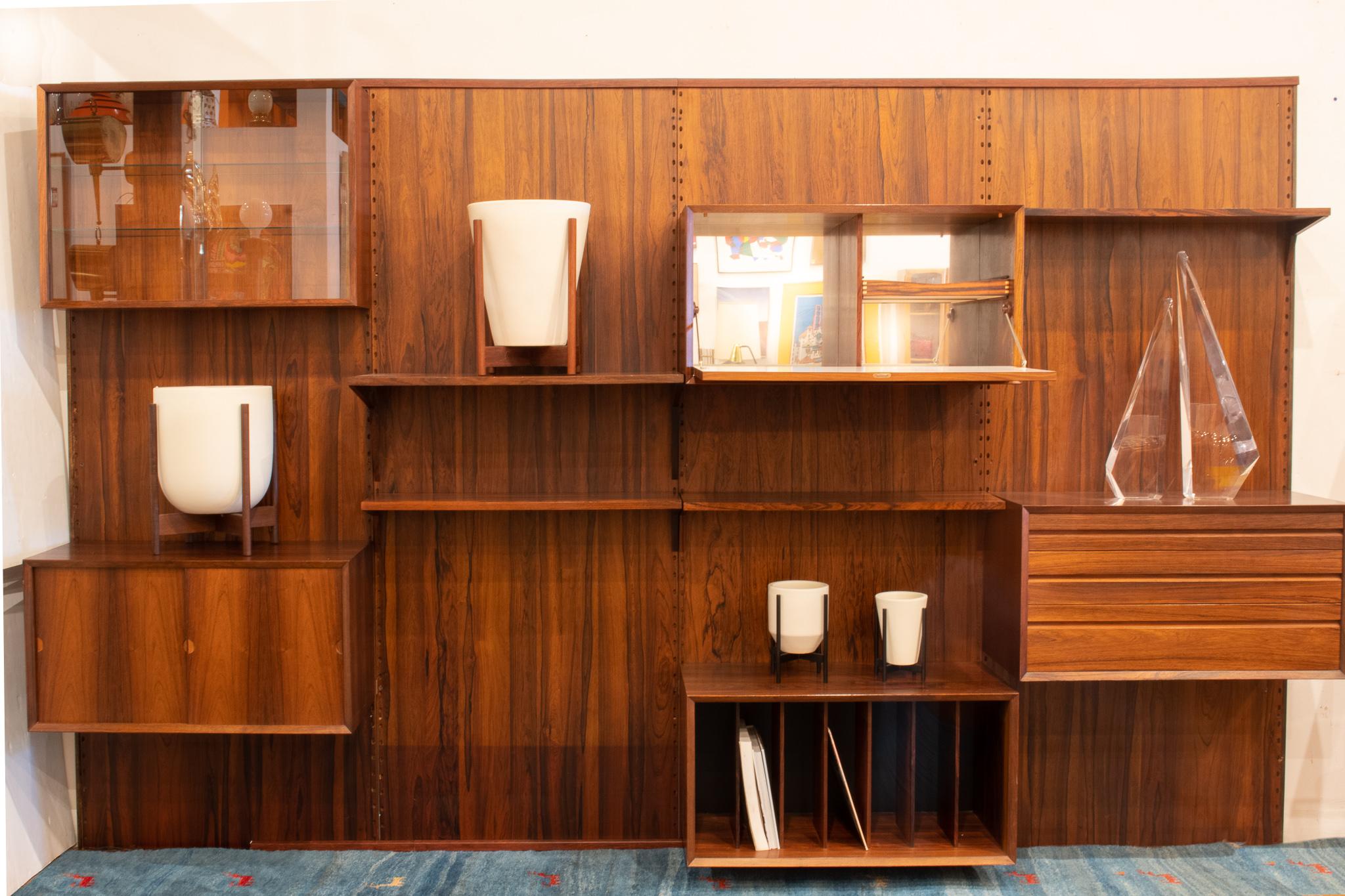 Large wall unit, shelving system by Cado Denmark designed by Poul Cadovius in 1960s. This shelving system is made of Brazilian rose wood. The system allows arranging in multiple configurations. This unit is in good lived in condition. Measure: 81.5