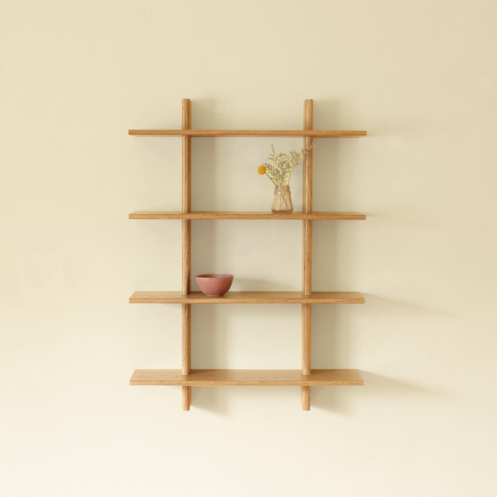 Solid white oak wall hanging shelves. Thin shelves and rounded faces add visual lightness. Meticulous precise joinery creates a sturdy surface. Hardware hidden behind shleves. This item is made to order by hand one at time. Currently turnaround time