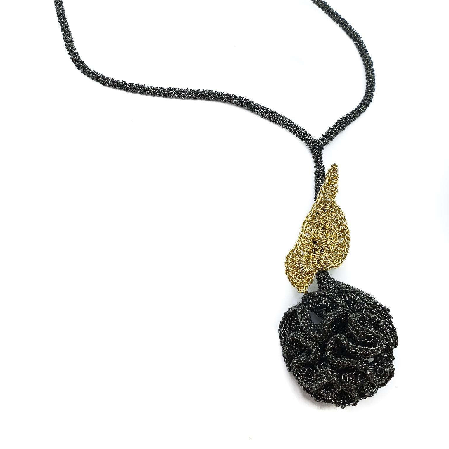 A flower can not  blossom without the sunshine. A crochet golden bird on a black thread flower necklace. It is shedding light and warmth wherever it lands.
 
This delicate necklace is crochet with a smooth passing thread. It is a cotton thread