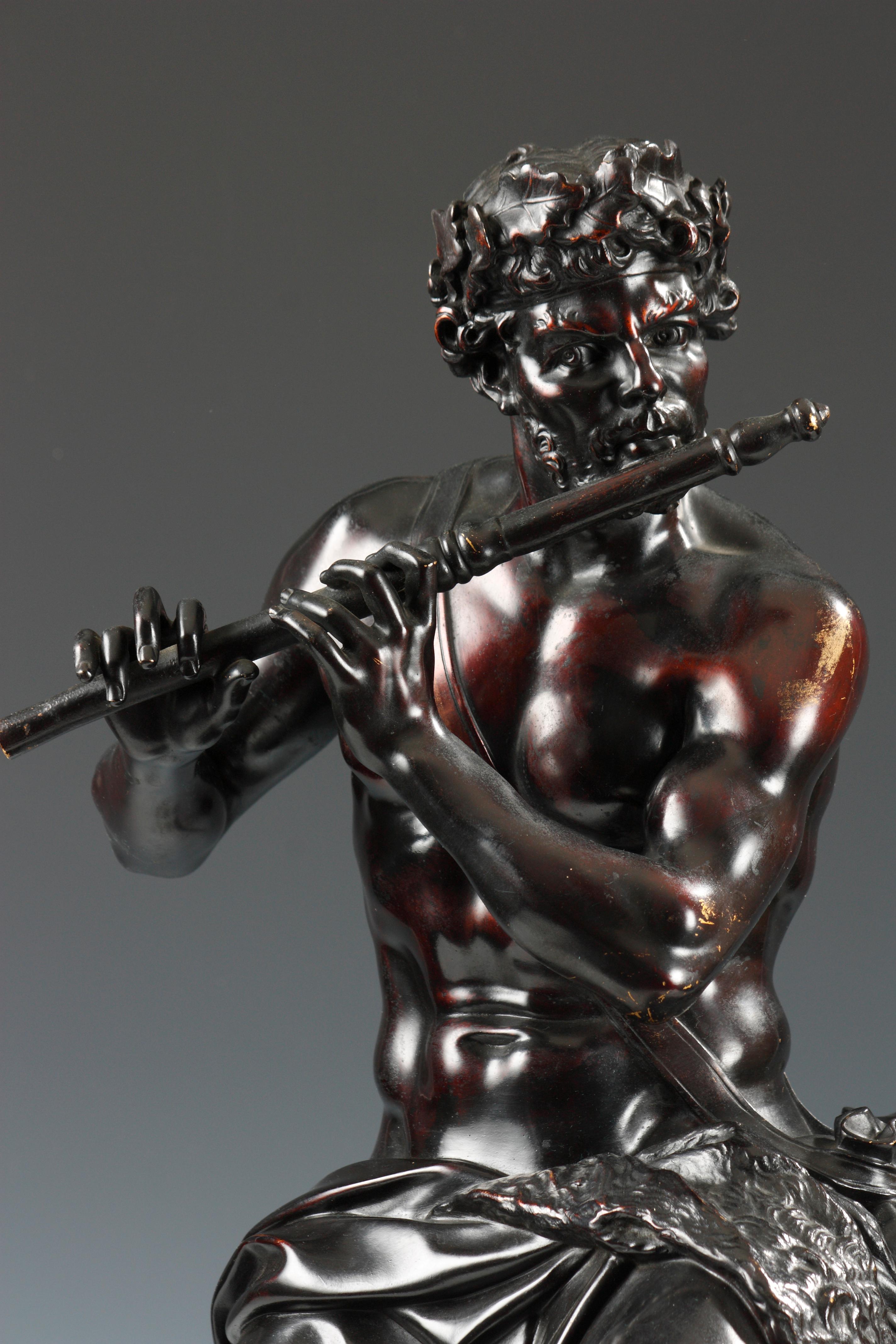 Signed F. Barbedienne Fondeur and stamped Achille Collas.

A patinated bronze figural group representing a shepherd playing his flute with a young centaur imposing silence at his sides. The group stands on a Louis XIV style gilded bronze