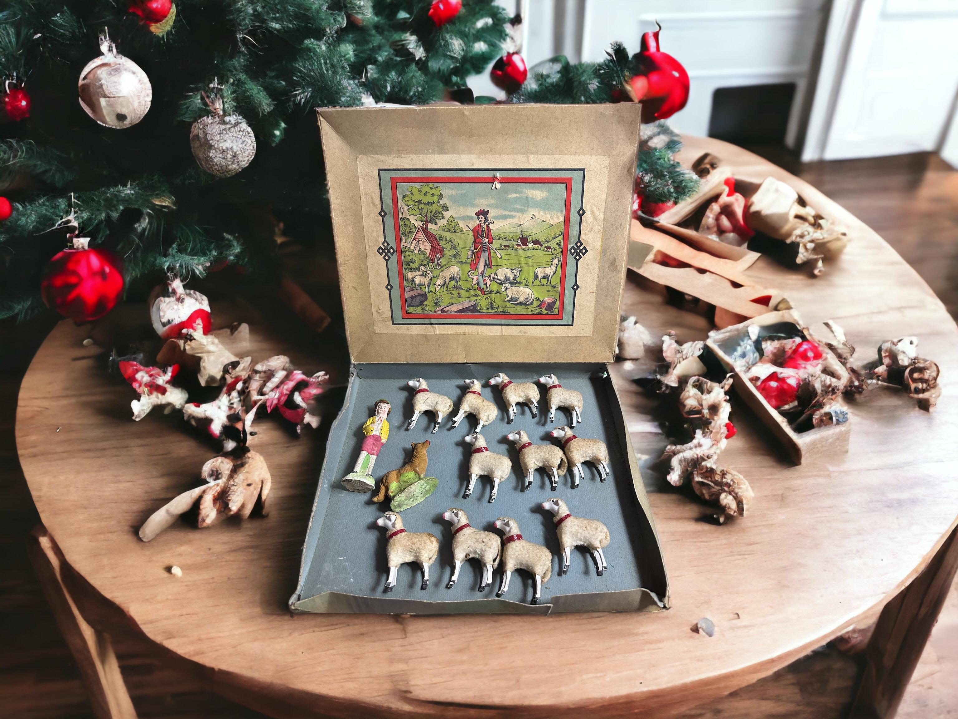 Antique German set of eleven Putz stick-legged sheep with a shepherd boy and his dog. All of them are genuine antique German Christmas nativity scene figures. As they are all old, most show the expected signs of age and use. This is a fabulous set,