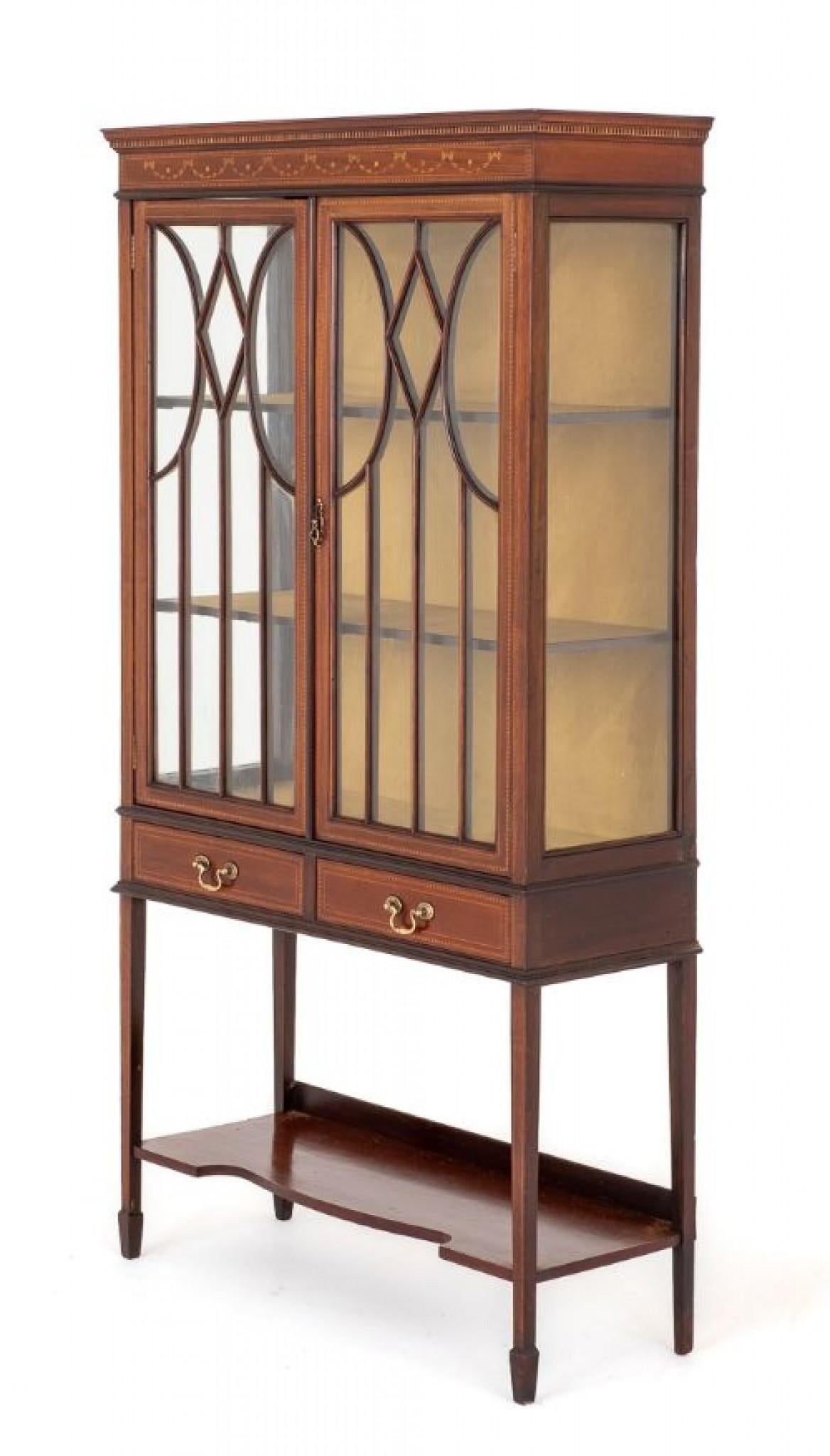 Sheraton Revival Mahogany Inlaid Display Cabinet.
Circa 1880
This Display Cabinet is Raised upon Tapered Legs with Spade Feet.
The Cabinet Features a Shaped Undertray.
Having 2 Mahogany Lined Drawers with Brass Swan Neck Handles.
The Astragal Glazed