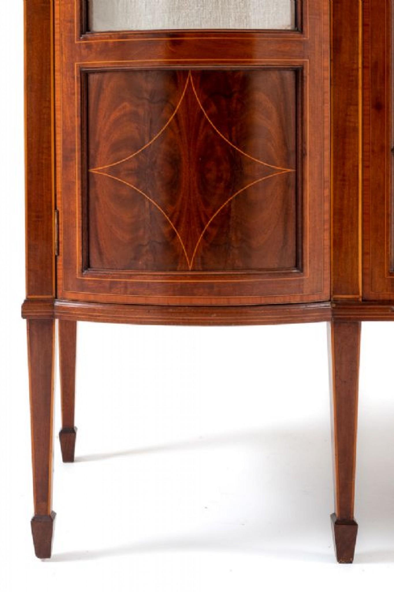 Sheraton Revival Mahogany display cabinet.
This Pretty Display Cabinet Stands Upon Square Tapered Legs With Spade feet.
circa 1890
Having an Astragal Glazed Central Door Flanked By Bow doors With Inlaid Panels.
The Tops of The Doors Having