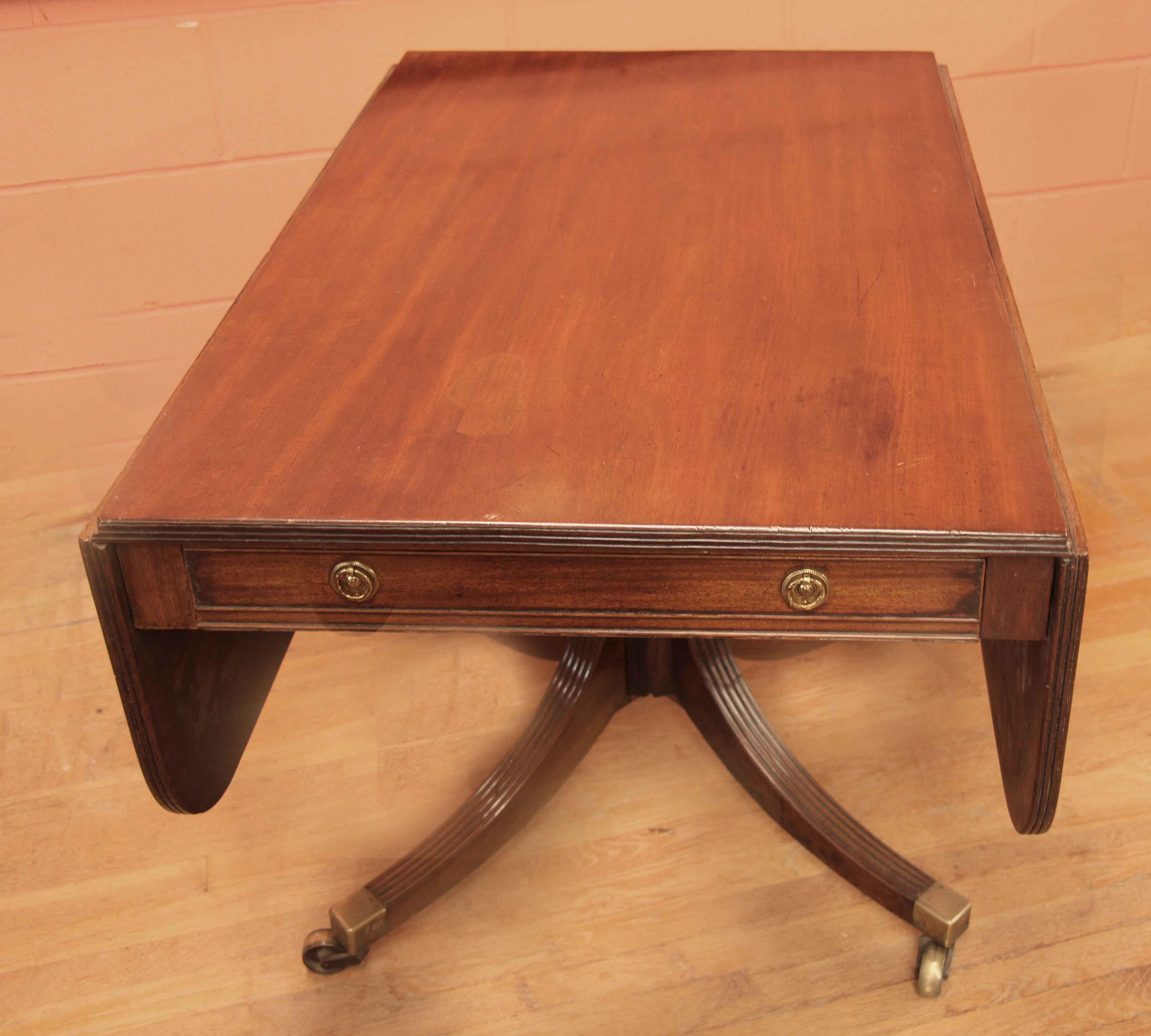 Sheraton drop leaf breakfast table, this mahogany table has beautiful color and antique patina, especially the top and leaves with reeded edges;  the two drop leaves are supported with double butterfly wings( see photo). There are identical drawers