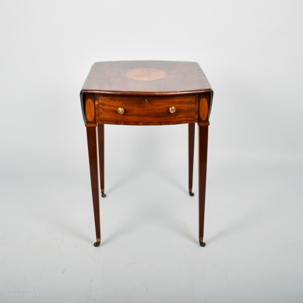 An extremely fine Sheraton style & period mahogany Pembroke table with satinwood shell inlay to the top. Of fine proportions and size with original colour. An exceptional example believed to be from the fine English furniture dealer Norman Adams.
