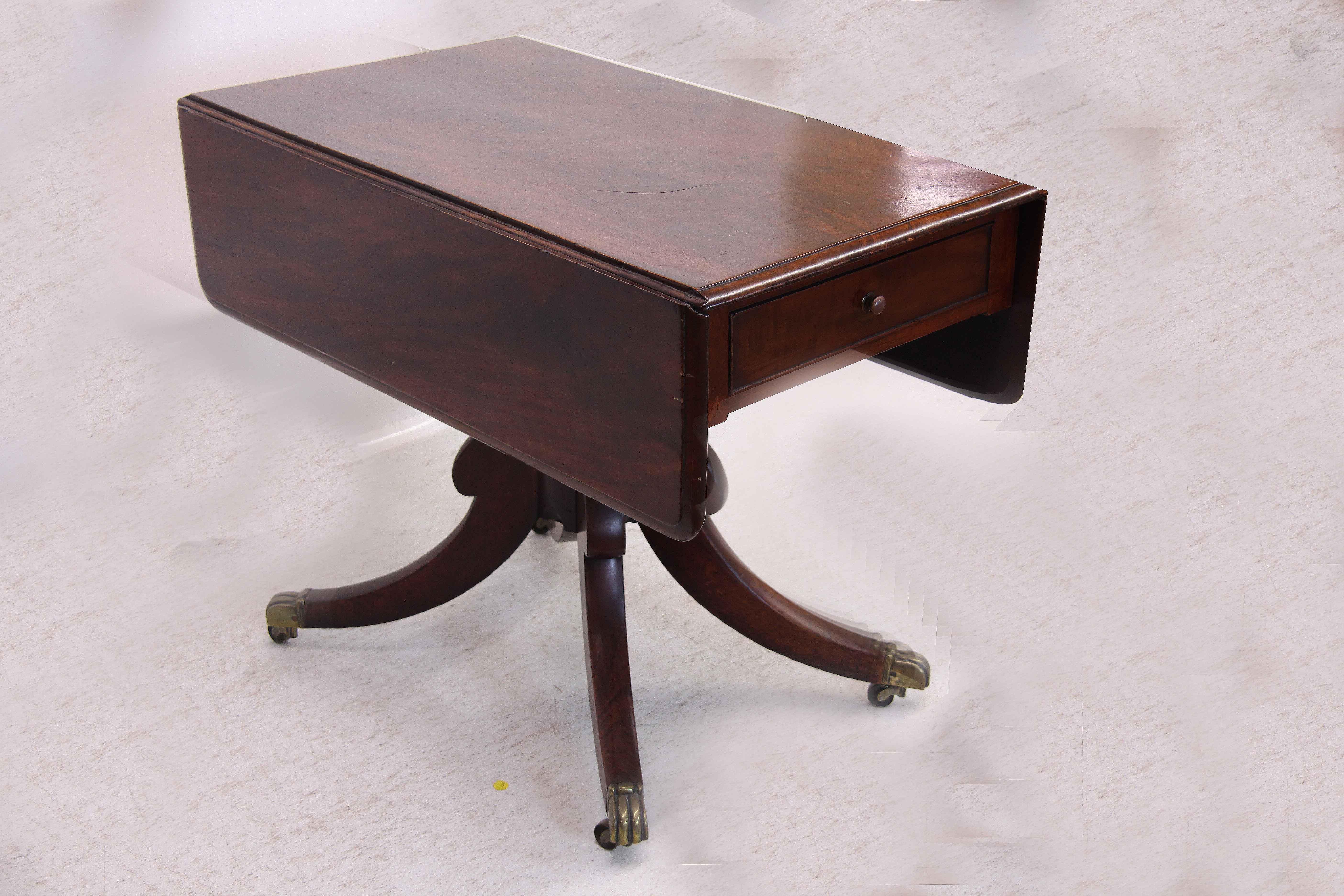 Sheraton drop leaf table, the top and leaves with beautiful figured mahogany, single drawer above nicely turned shaft with four legs terminating with original brass cup castors. The leaves are supported in the upright position with double