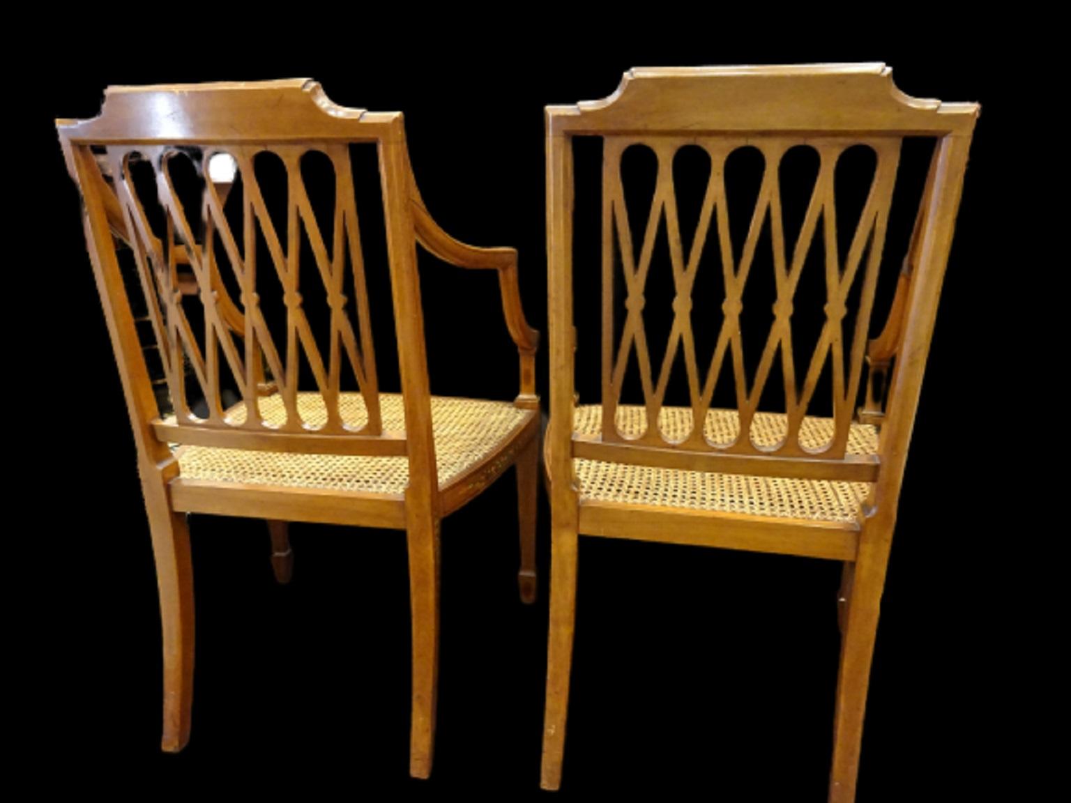 Stunning and amazing pair of armchairs, Sheraton style, 18th century, in satinwood and inlaid wod decorations, rams, leaves and flowers are the motifs.
They take lightweight rectilinear forms and have a landscape painting on the back, Meash