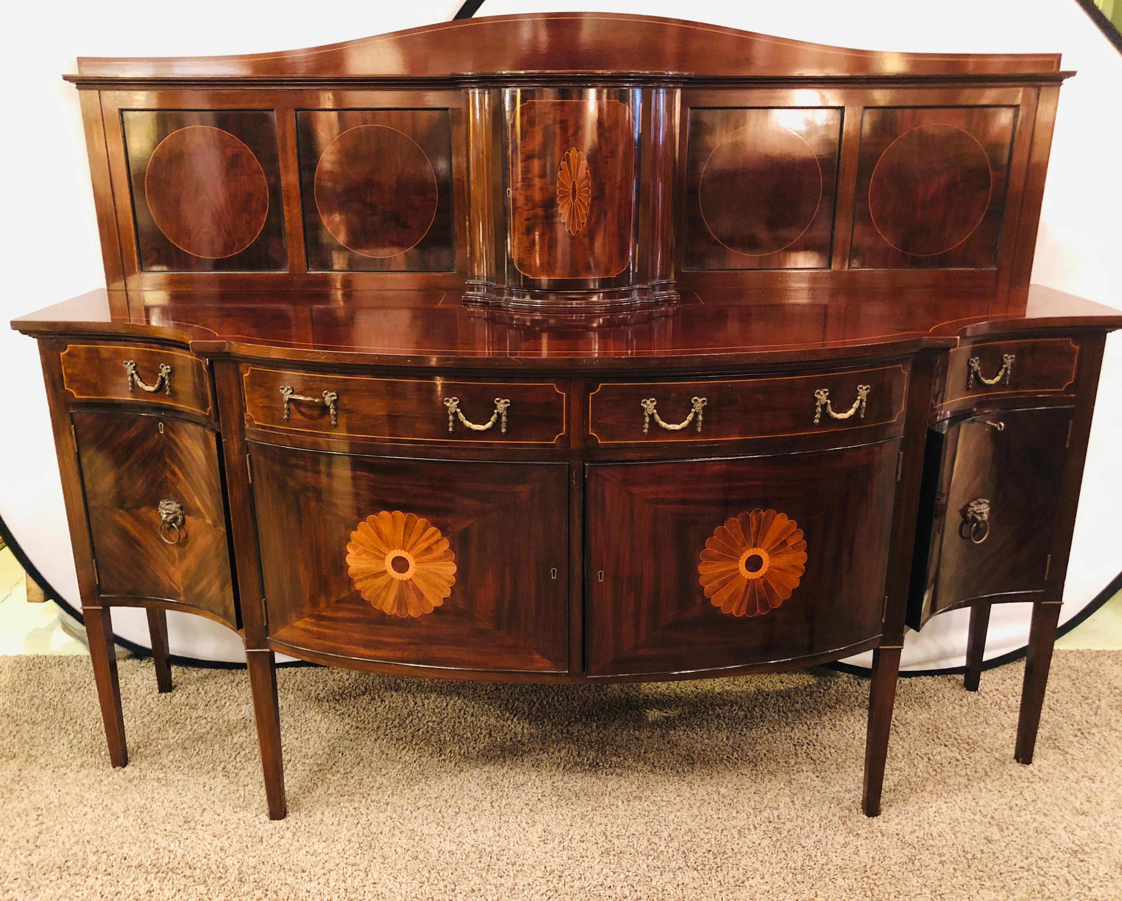 Palatial Thomas Sheraton style flame mahogany 19th century sideboard buffet with inlaid backsplash top. This stunning and spectacular sideboard can be used with or without the finely inlaid showcase backsplash. This seemingly timeless sideboard sits
