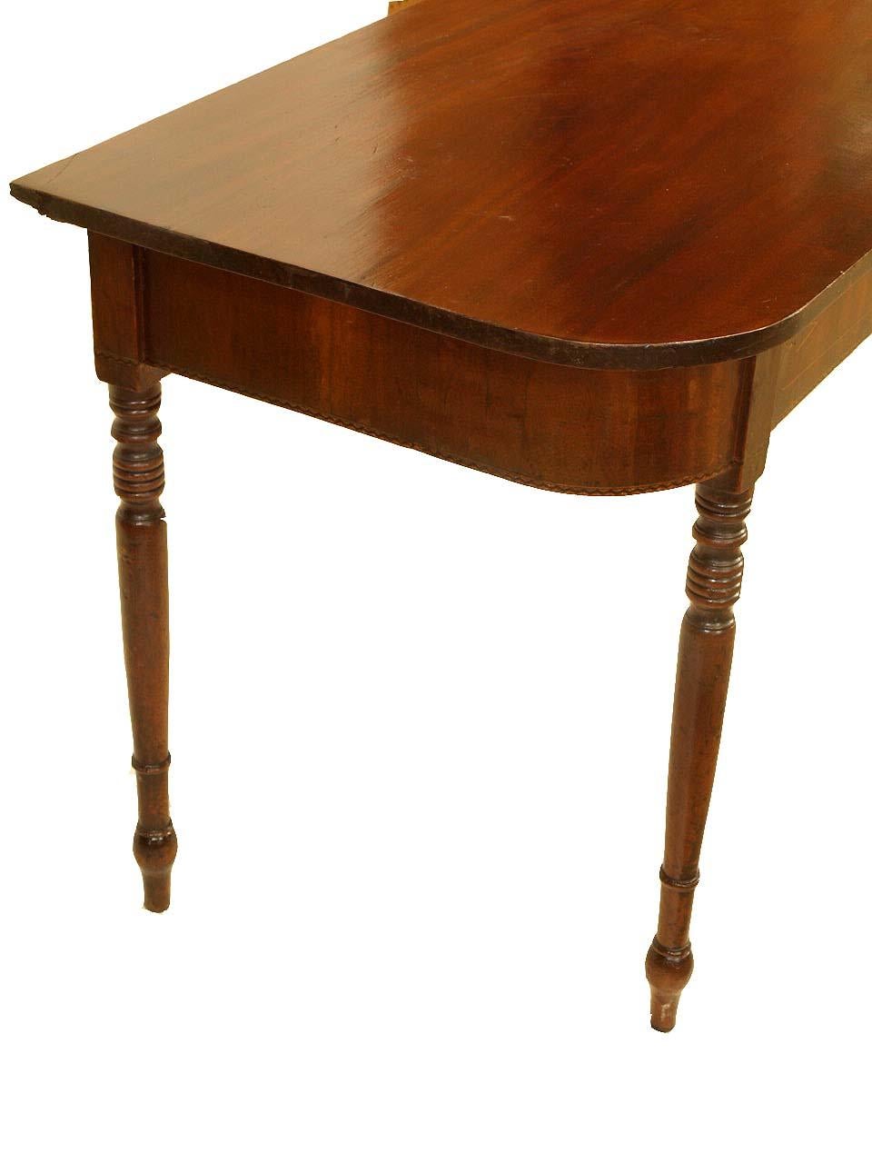 Sheraton mahogany console table, the front apron is veneered with flame mahogany and is inlaid with boxwood and has a band of decorative inlay along the bottom edge, the turned legs are very well proportioned, beautiful color and patina throughout .