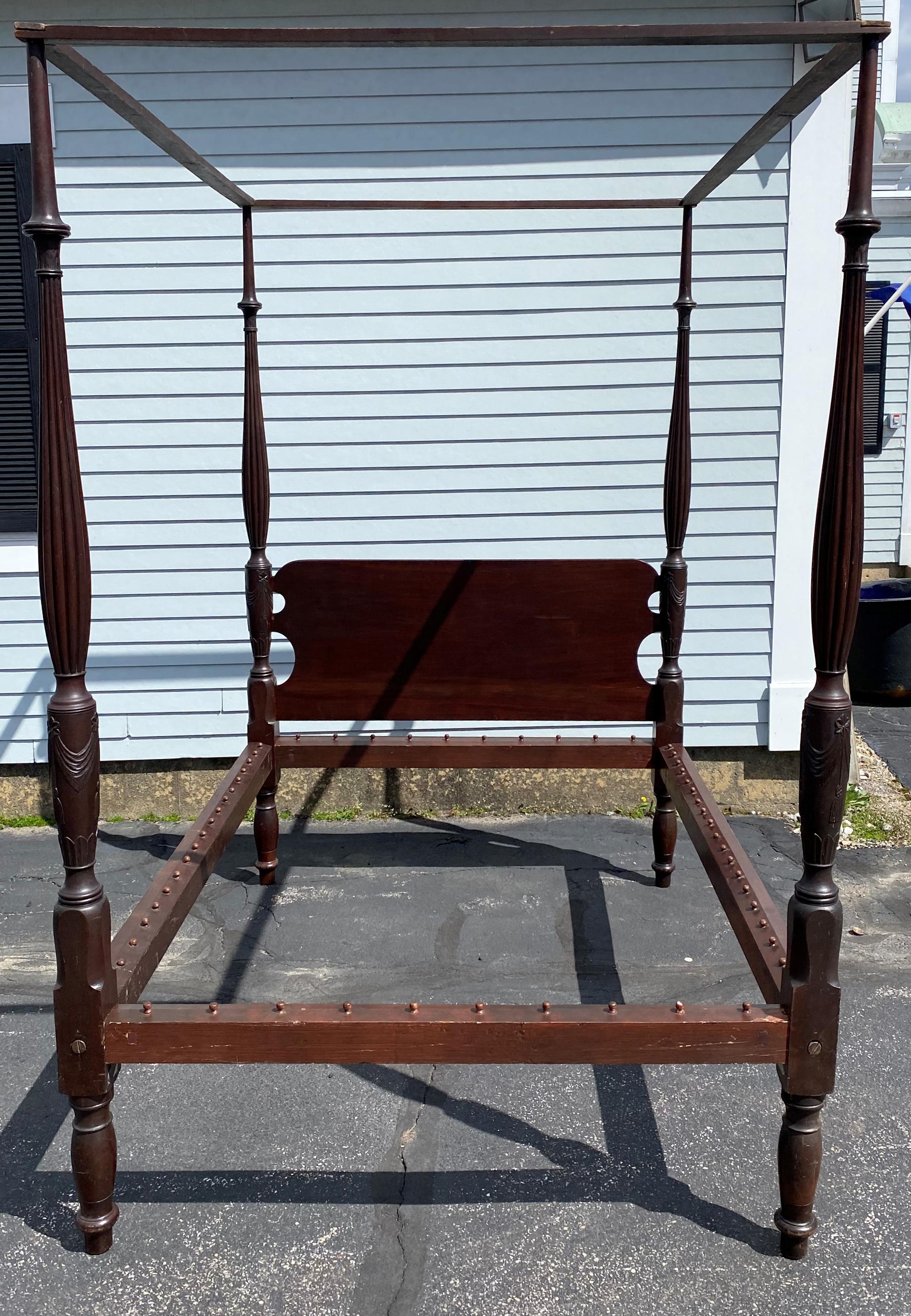 A fine Sheraton mahogany full size bed with carved shaped posts featuring swag,tassel, & foliate relief decoration along with reeded tops, and includes its original tester. Comes with decorative foliate hardware cover plates, hardware, and bed