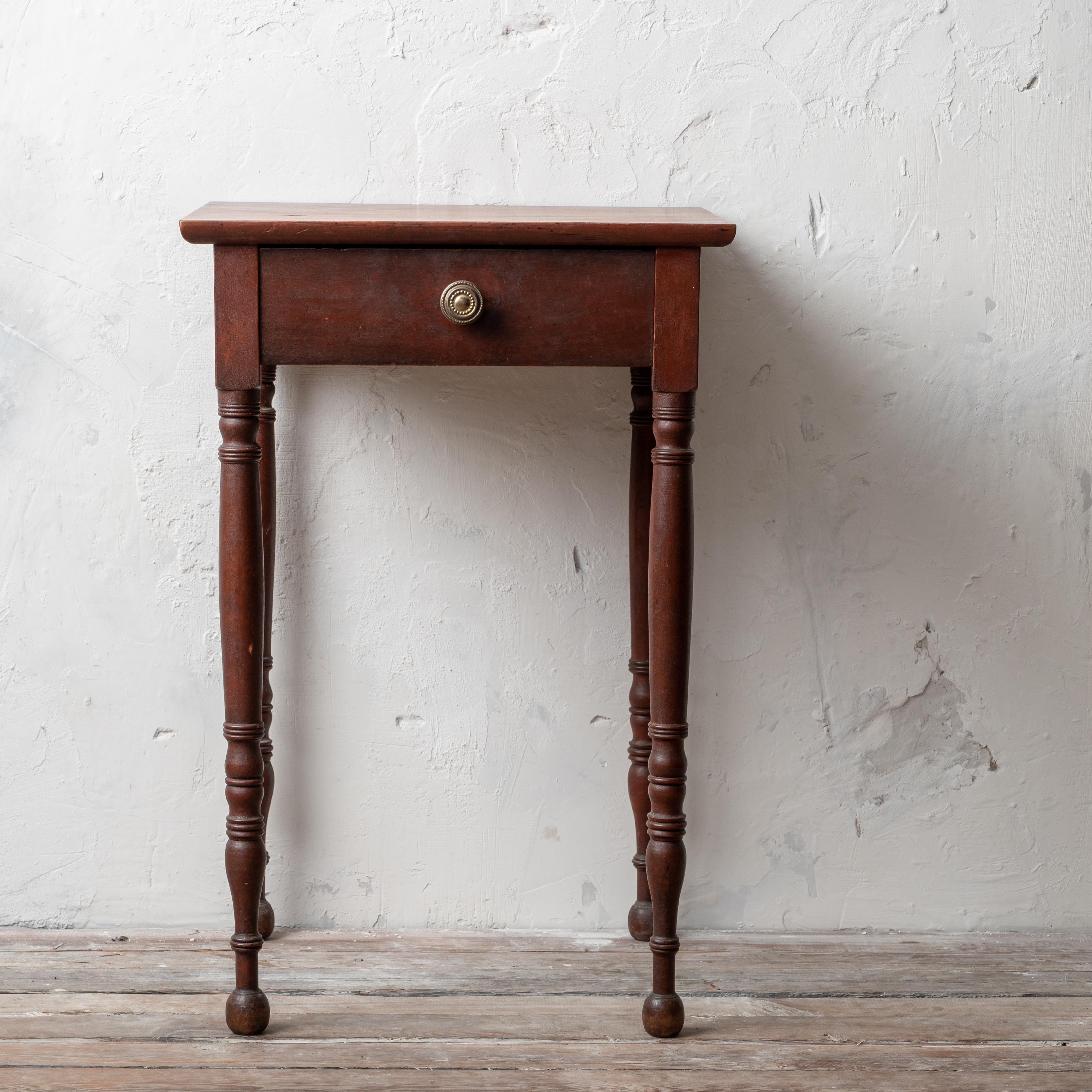 A Sheraton mahogany one drawer stand, American, circa 1810s. 

18 ¾ inches wide by 17 ¾ inches deep by 28 ¼ inches tall

