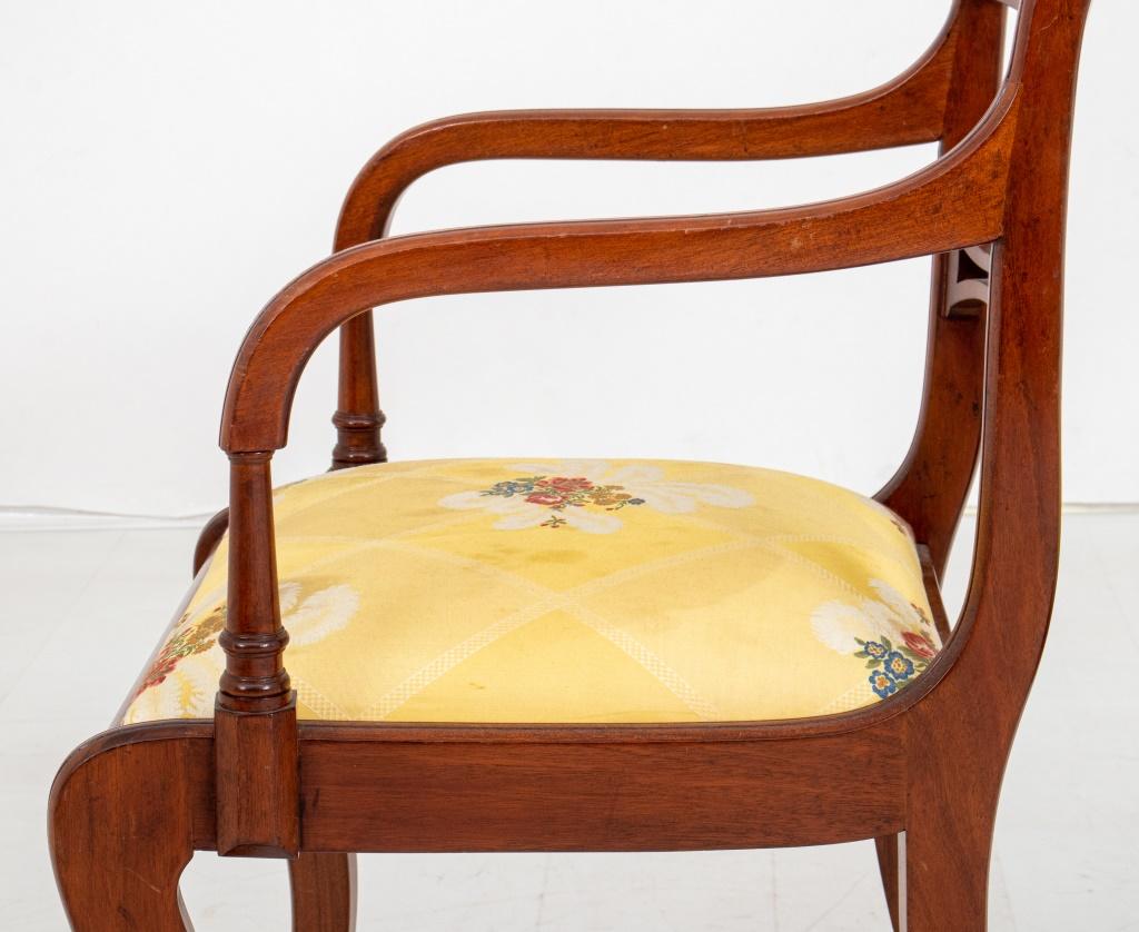 et of painted satinwood dining chairs in the manner of Thomas Sheraton (English, 1751-1806)  comprising two arms and six sides, each with curved crestrail painted with flowers above downswept arms, each with drop in upholstered seat in yellow