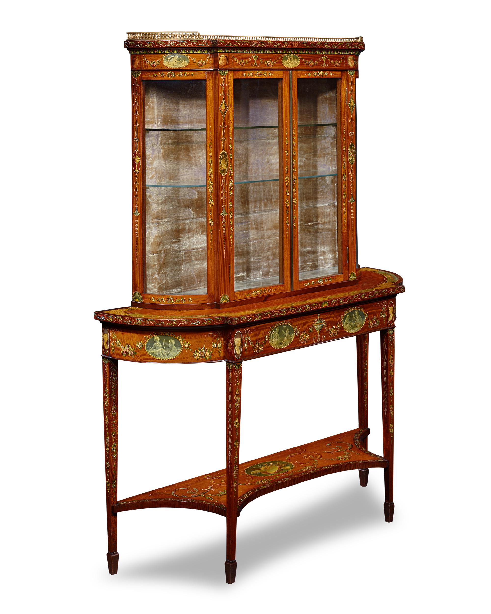 This exceptional English vitrine features the stylistic elements associated with the famed English furniture designer Thomas Sheraton, considered one of the three most influential English cabinetmakers along with Thomas Chippendale and George