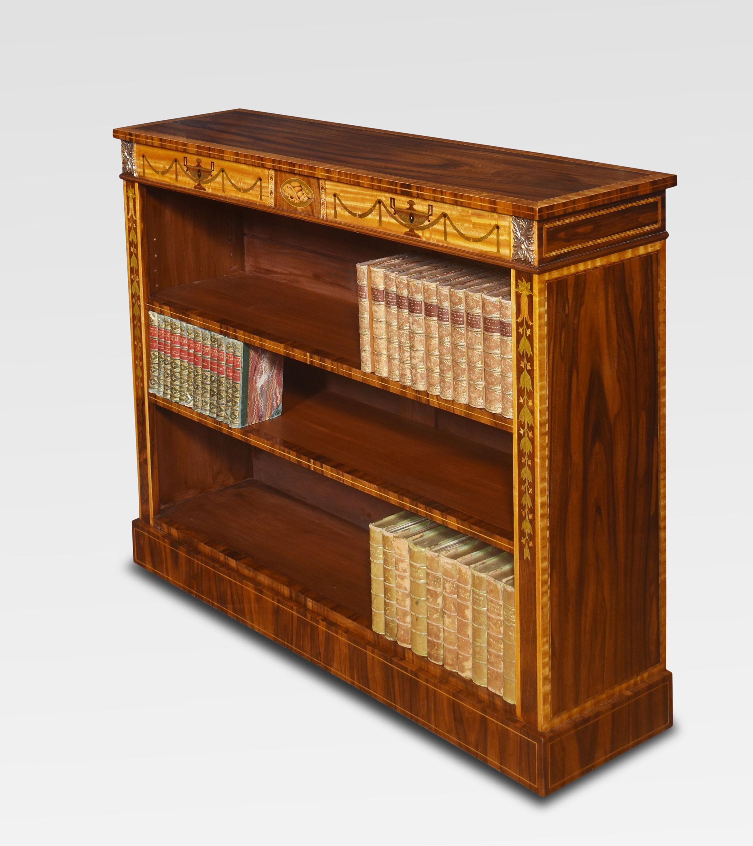 Sheraton revival bookcase, the rectangular cross banded top above the inlaid urn and ribbon tied swag decorated frieze. The bookcase is fitted with two adjustable shelves. All raised up on a plinth base.
Dimensions
Height 37 Inches
Width 43