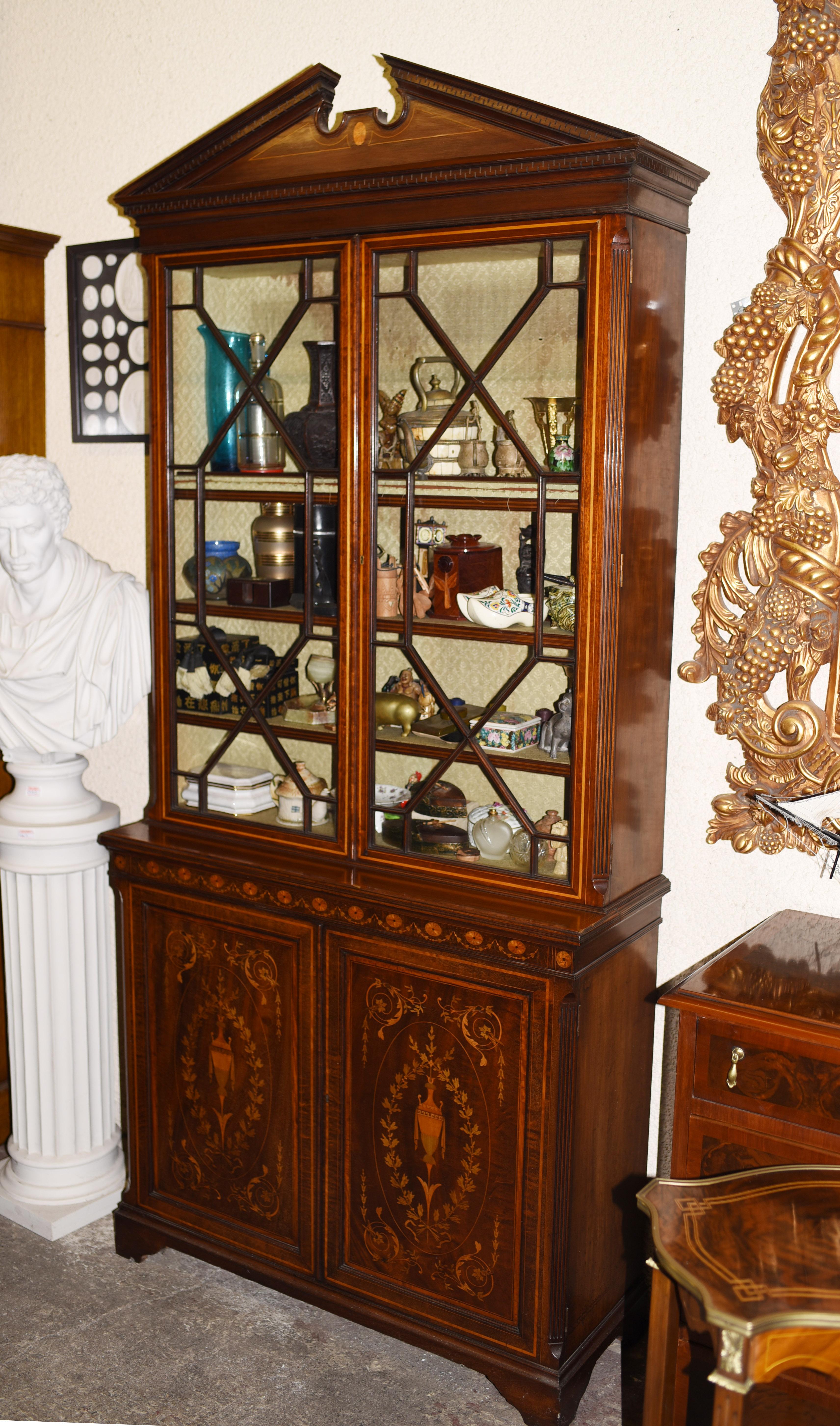 Gorgeous Sheraton revival mahogany bookcase
Classic broken arch pediment to the top
Intricate inlay work includes floral motifs and urn motifs
Offered in great shape ready for home use right away
We ship to every corner of the planet.
All our