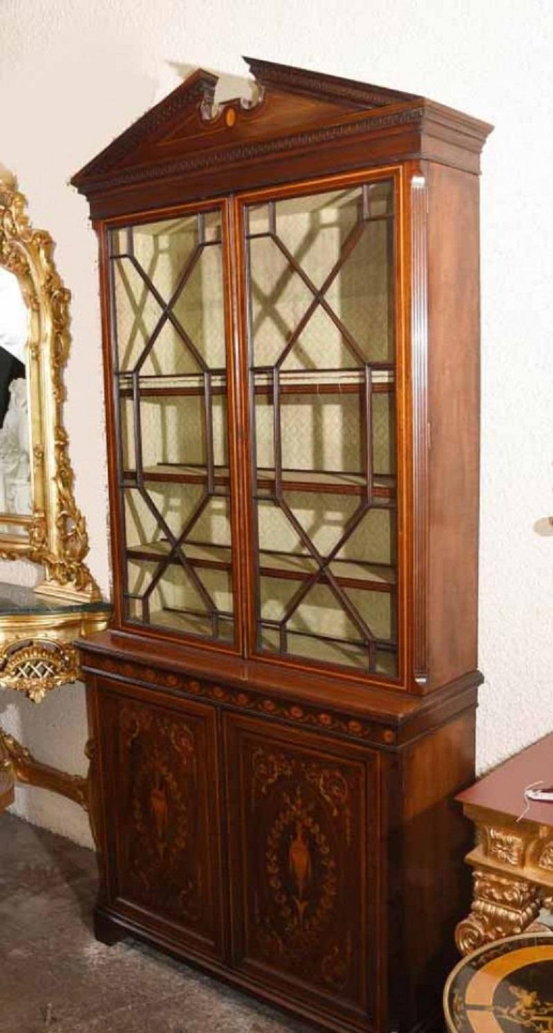 Gorgeous Sheraton revival mahogany bookcase
Classic broken arch pediment to the top
Intricate inlay work includes floral motifs and urn motifs
Offered in great shape ready for home use right away
We ship to every corner of the planet
All our