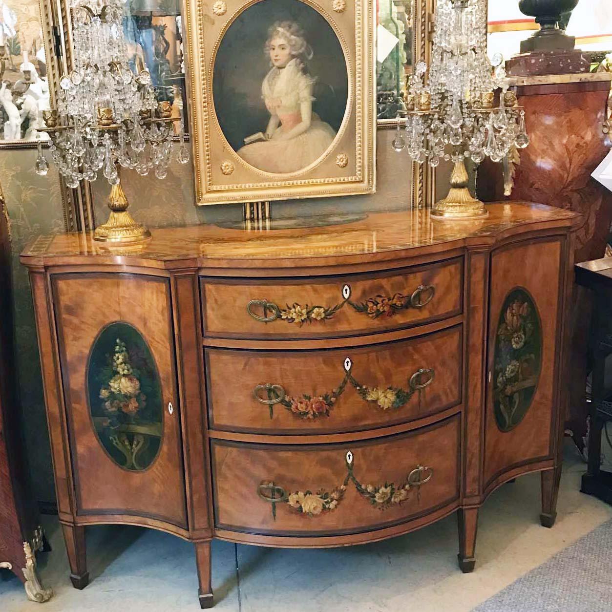 This very fine Sheraton Revival painted satinwood side-cabinet is of breathtaking quality, each drawer and panelled door fits precisely. The central demilune section is enclosed by three graduated drawers and is flanked by gracefully curved panelled