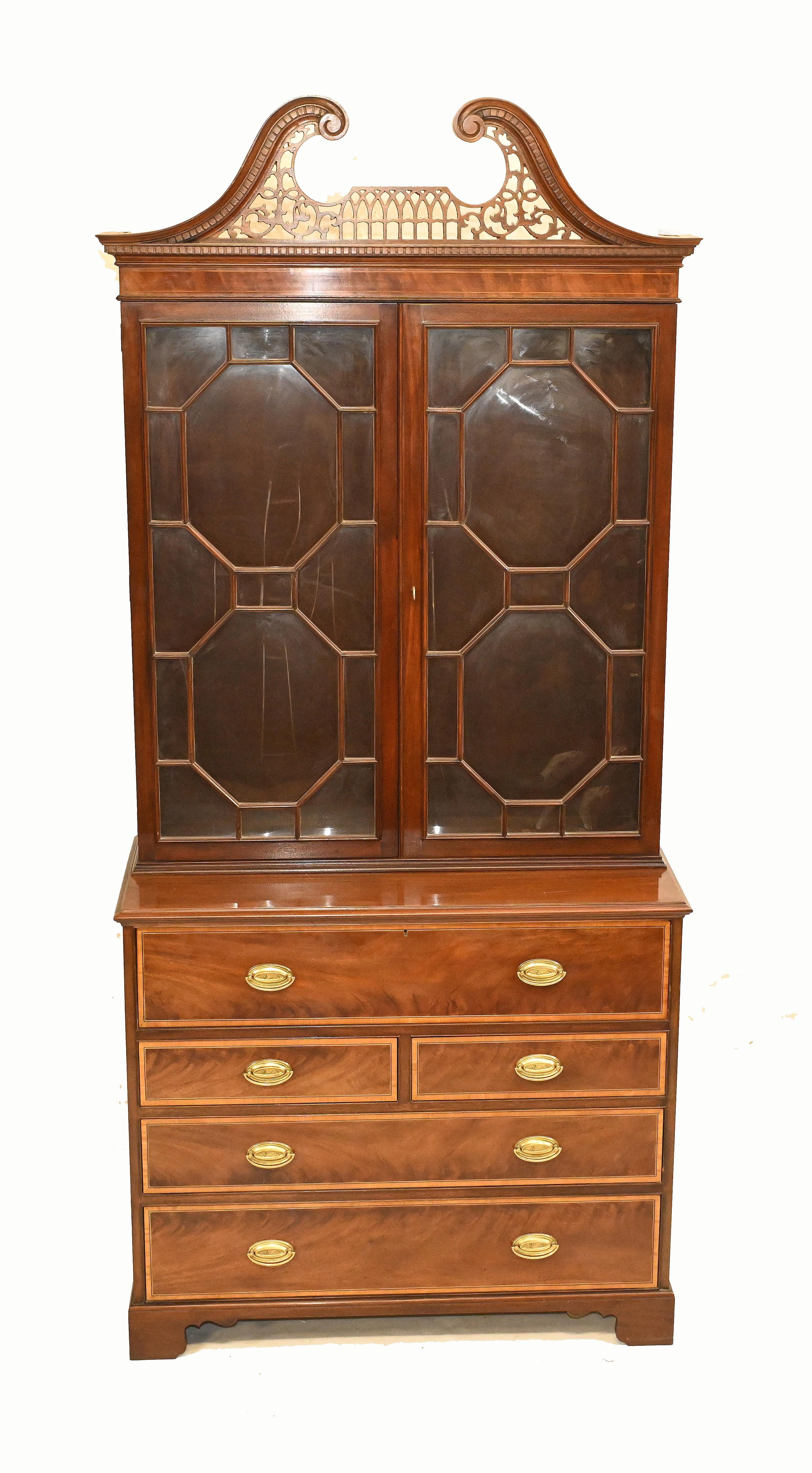 Gorgeous Sheraton style secretaire bookcase in mahogany
Flame mahogany with satinwood crossbanding
Desk section opens out below glass fronted top to reveal writing surface
Also cubby holes and drawers
Also bearing a Michael Davies shipping label