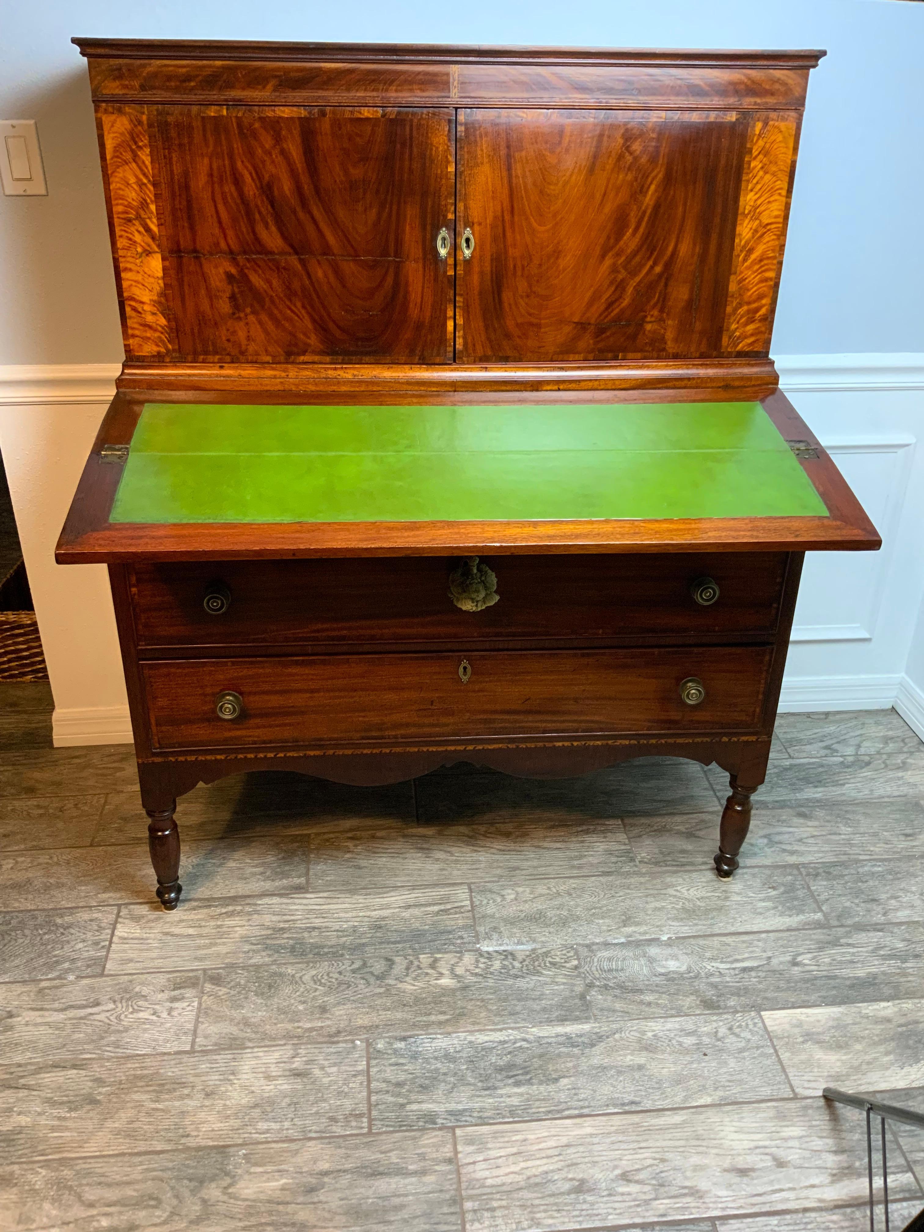 A very fine Sheraton Secretary Desk 1810-1820 in a old refinish with an excellent color and patina.  Decorative cross banded veneers and inlay work throughout add to the beauty of this piece.  Beautifully cut scalloped apron on the front and sides. 