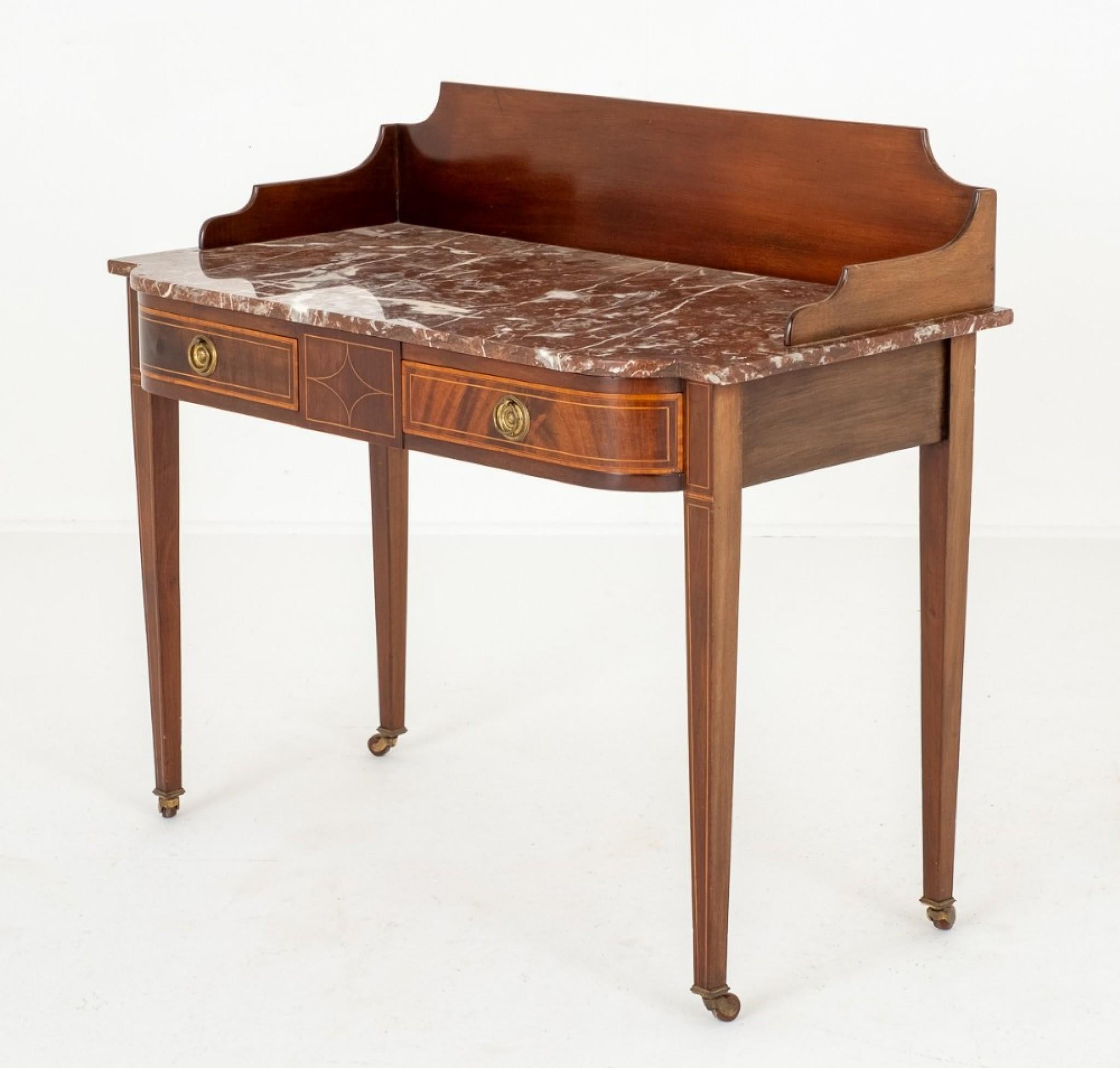 Sheraton Revival Mahogany Marble Top Side Table.
Circa 1890
Raised Upon Tapered Legs with Original Brass and Porcelain Castors.
The Shaped Front Features 2 x Oak Lined Drawers with Original Brass Ring Pull Handles.
The Legs and Drawers Feature