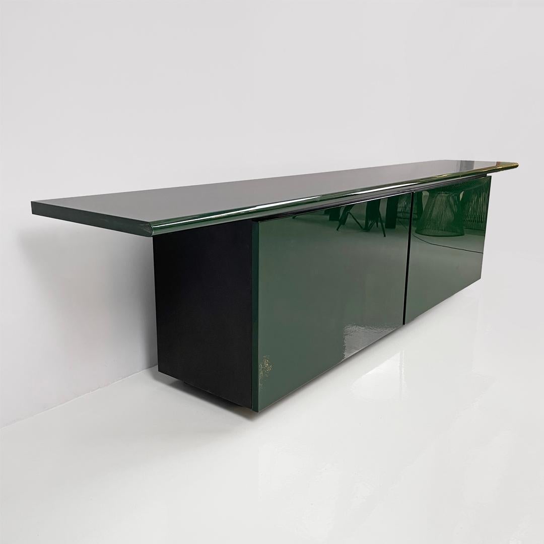 Sheraton sideboard by Giotto Stoppino and Lodovico Acerbis for Acerbis, 1980s
Sheraton model sideboard, with structure entirely in glossy green lacquered wood. The rectangular top has a beveled front edge, on the front there is a row of four black