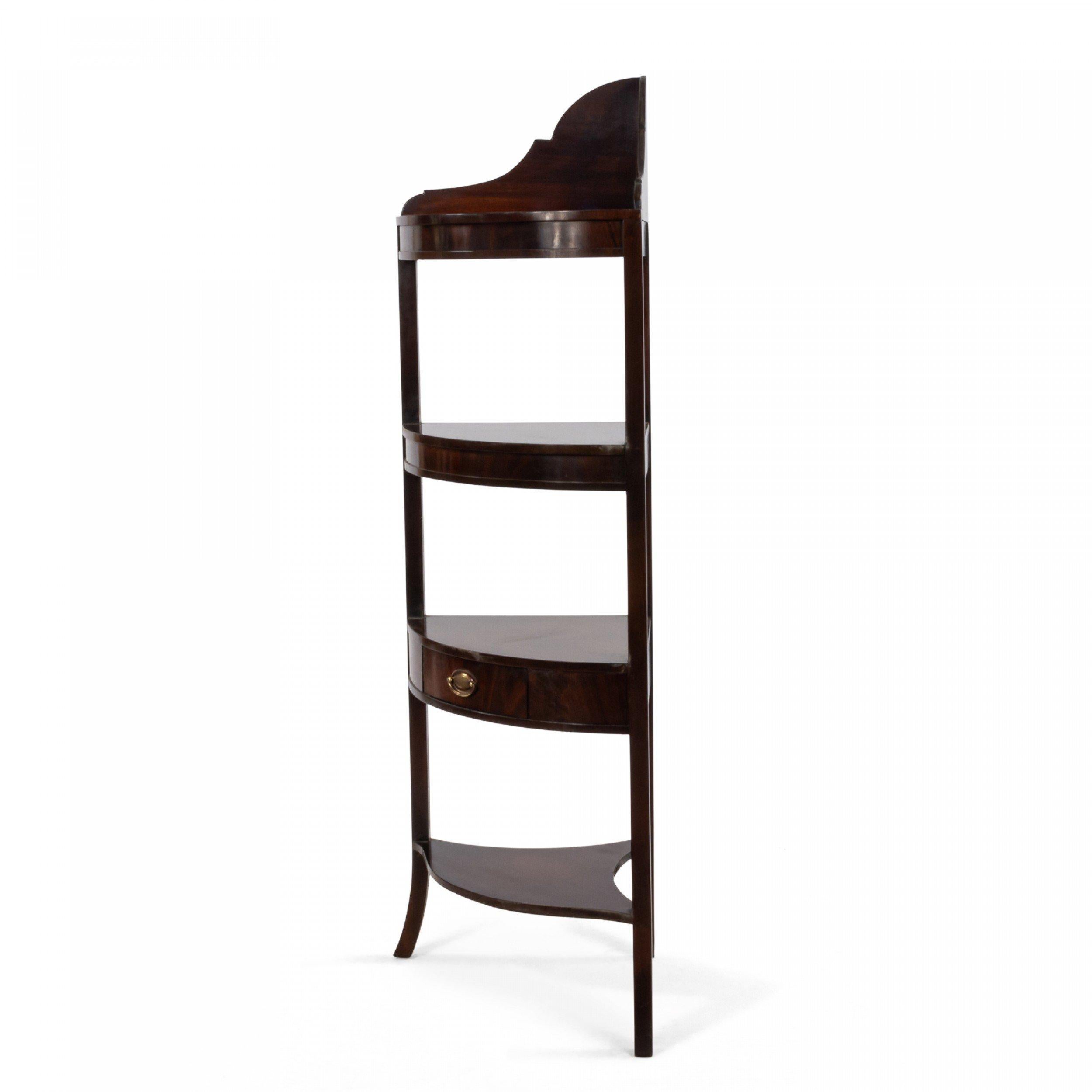 English Sheraton style 20th century mahogany three-tier corner etagere with drawer supported on splayed feet.