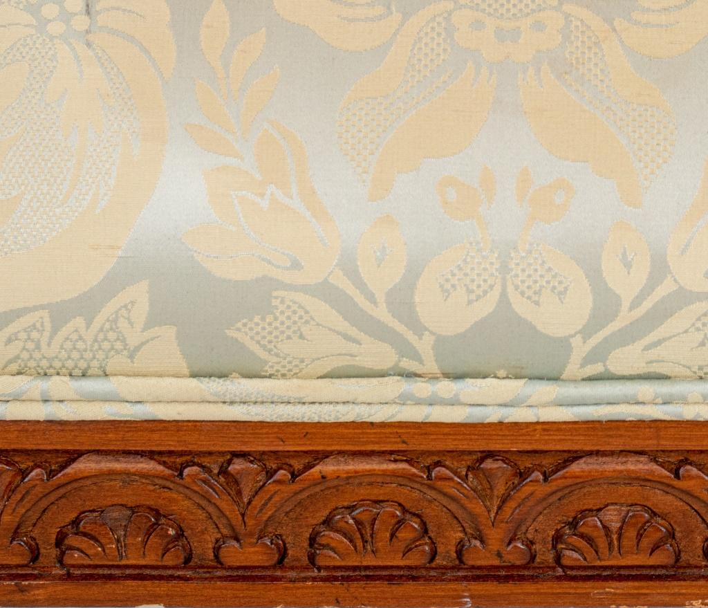 Sheraton Style Upholstered Mahogany Hall Bench,  in the manner of Thomas Sheraton (English, 1751-1806)  with upholstered scrolling arms, allover uphosltered in brocade, the supports in form of feathers, the seat rail elaborately carved and on fluted