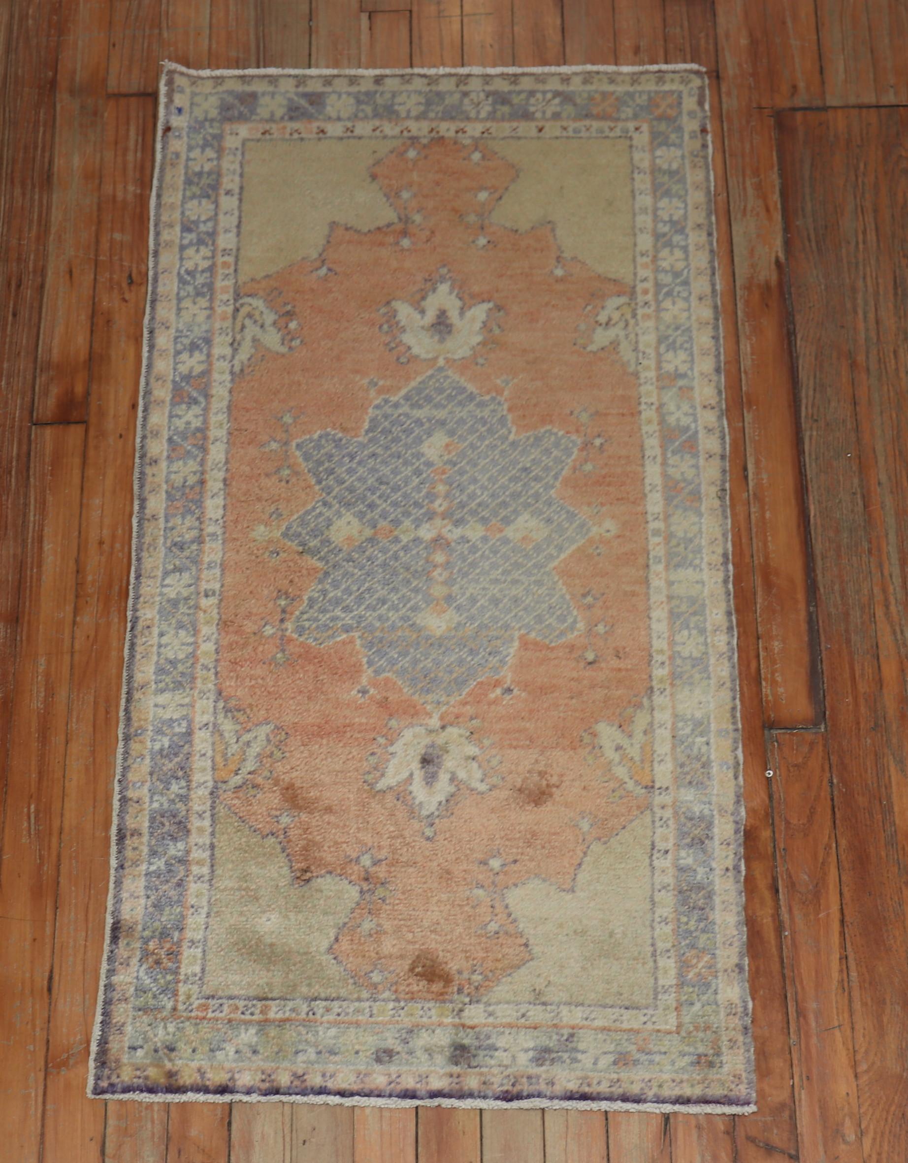 An antique Turkish oushak small rug in sherbert and green.

Measures: 2'1'' x 4'.