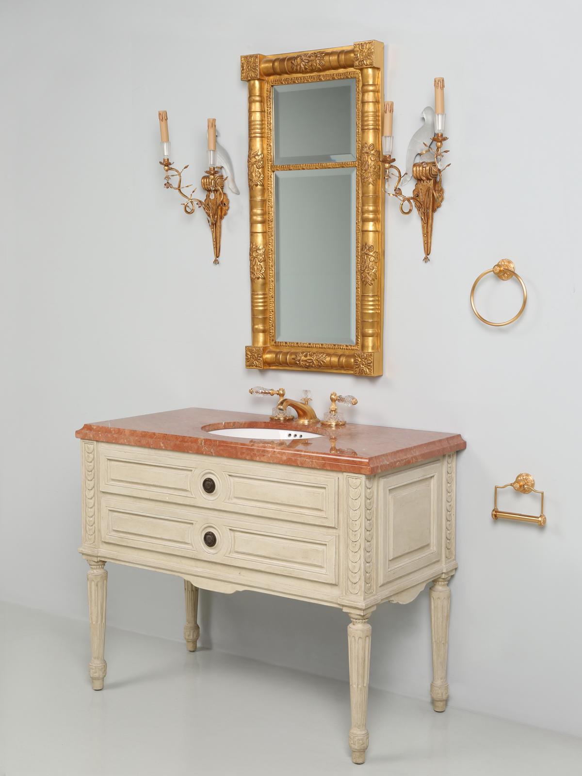 French Louis XVI style Bathroom Vanity from Sherle Wagner with all the accessories. The Sherle Wagner bathroom set includes the Louis XVI style painted vanity, with the white ceramic under edge sink accented with acanthus burnished gold, the famous