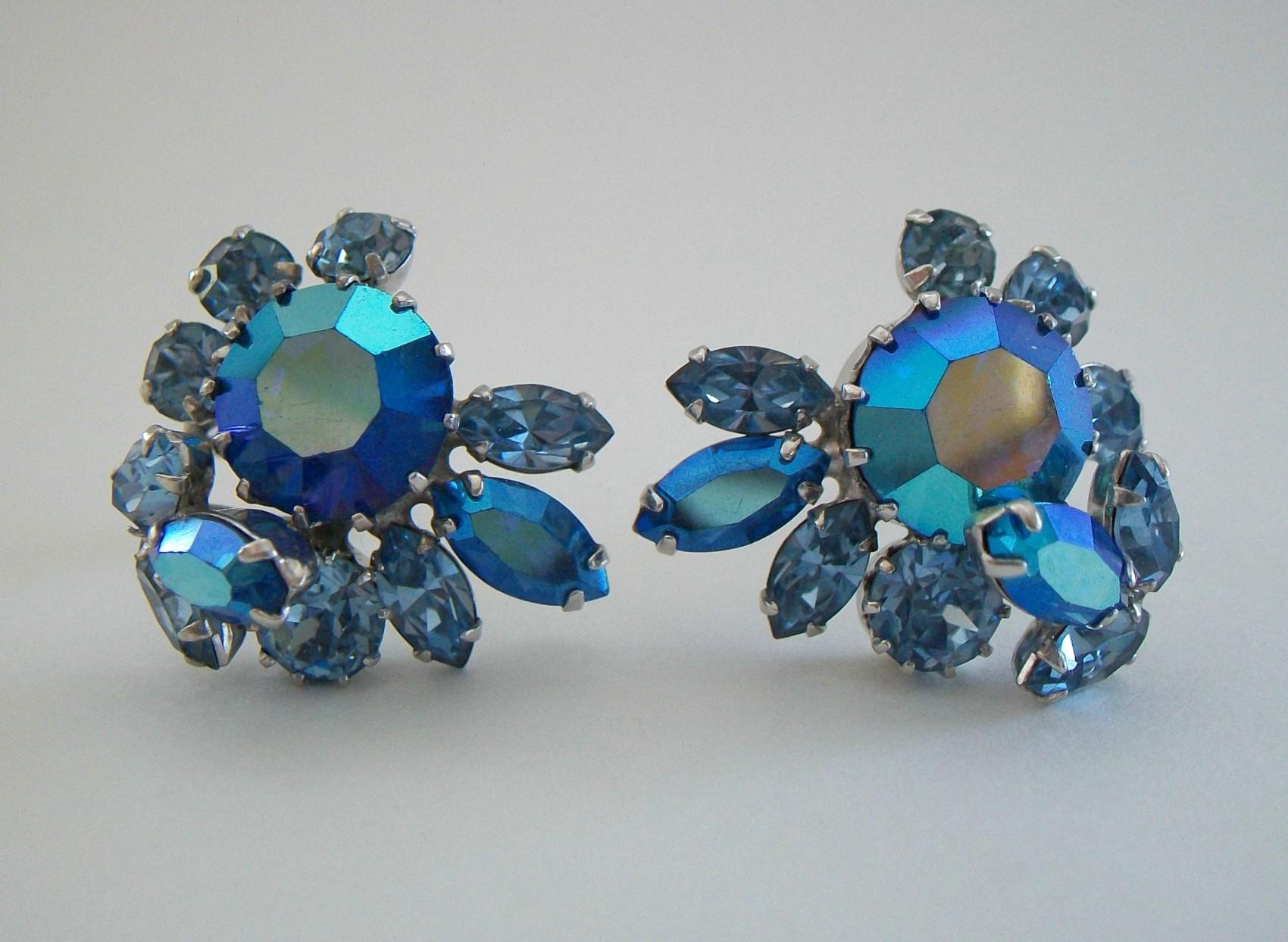 SHERMAN - Vintage pair of Aurora Borealis and blue crystal ear clips - featuring a large round faceted crystal to the center of each earring, surrounded by smaller marquis and round shapes, all prong set - signed on the back of each ear clip (see