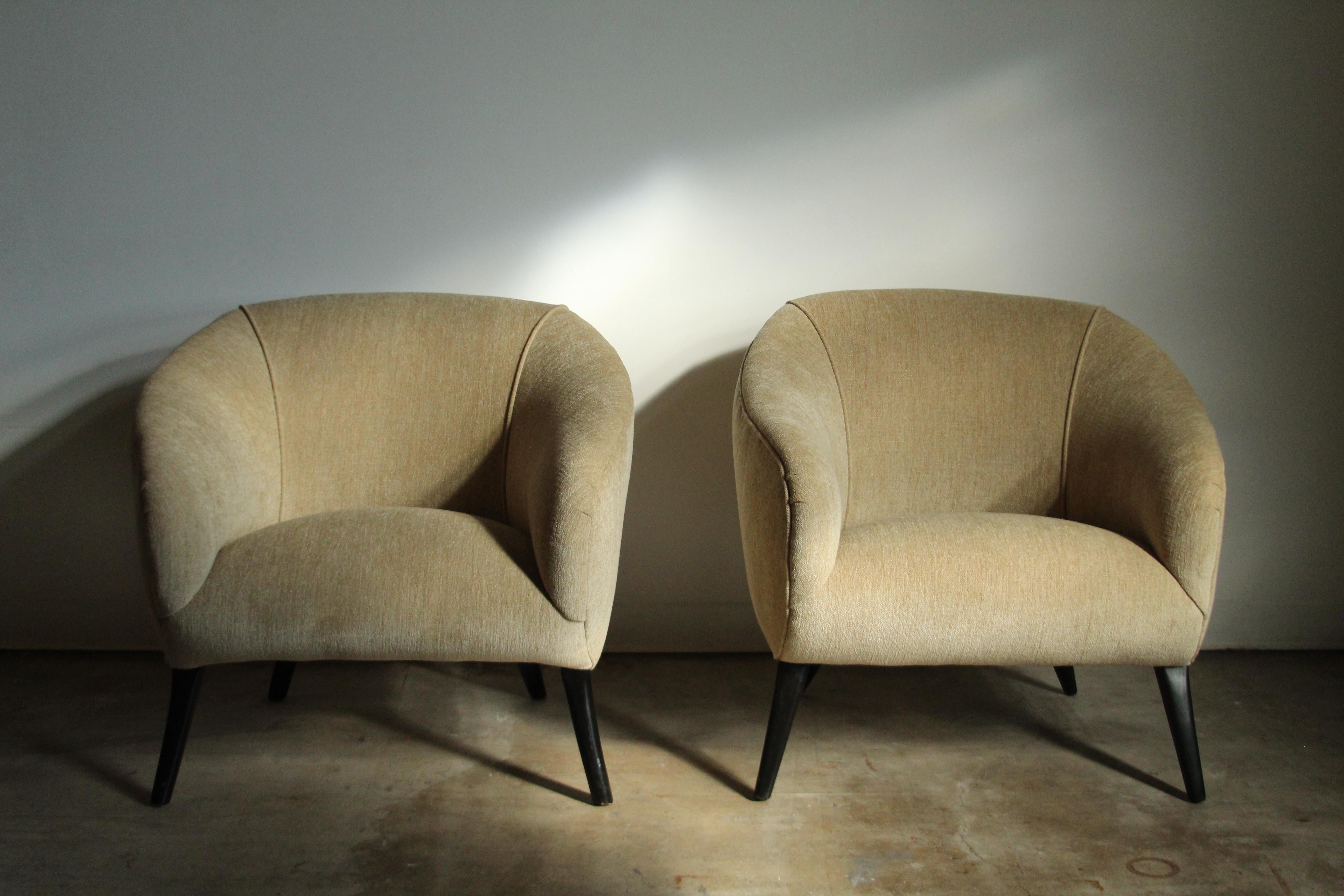 A wonderful pair of California modernist lounge chairs manufactured by Sherman Bertram in the 1940s. These sculptural beauties have undergone a full restoration and are in excellent condition. They have been beautifully reupholstered in a vintage