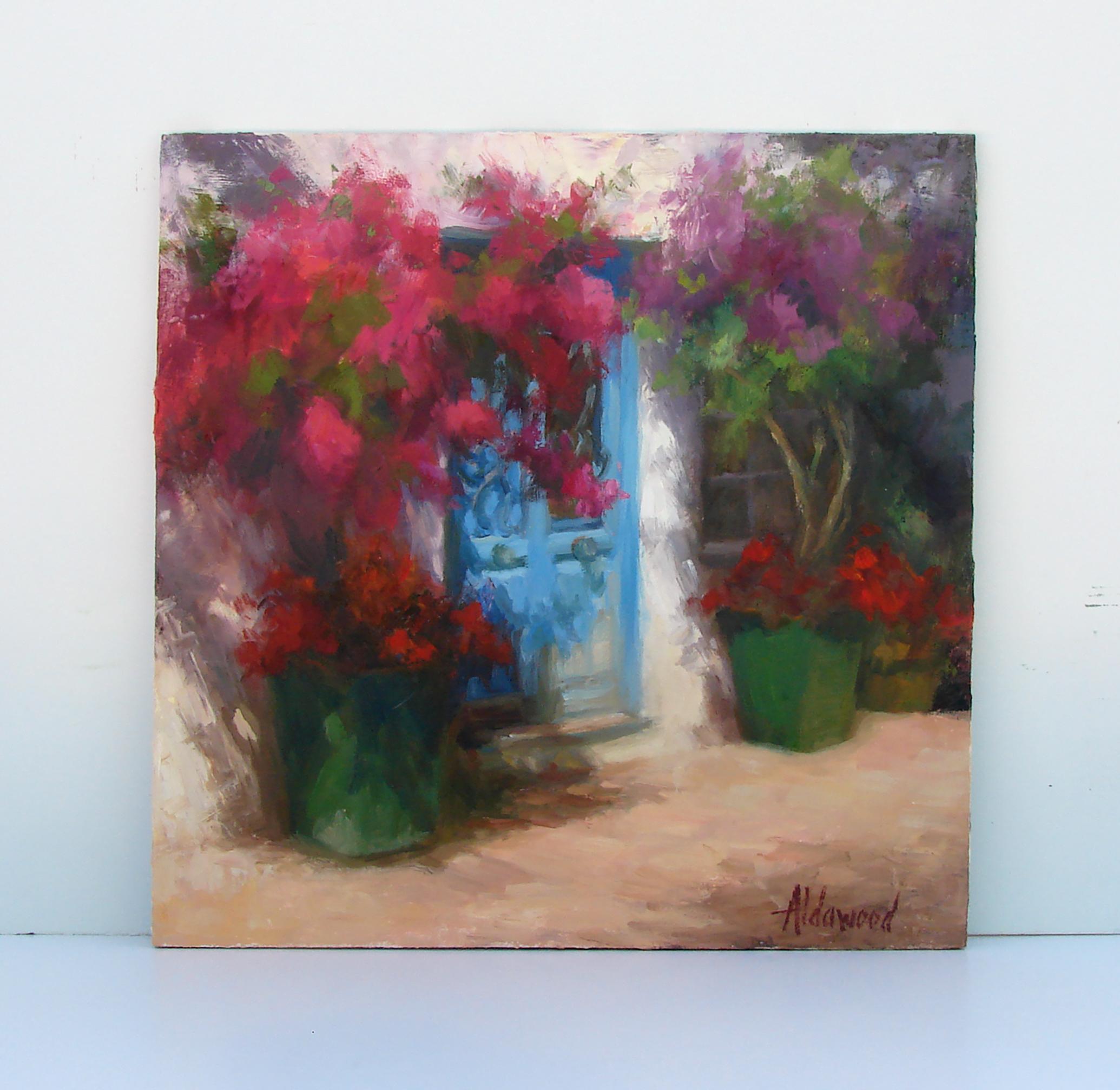 <p>Commenti dell'artista<br />Vibranti bougainvillea incorniciano una porta blu rovinata dalle intemperie, con fiori rossi a cascata su vasi verdi. La morbida luce del sole aggiunge calore e charme alla scena. L'artista Sherri Aldawood ha incontrato