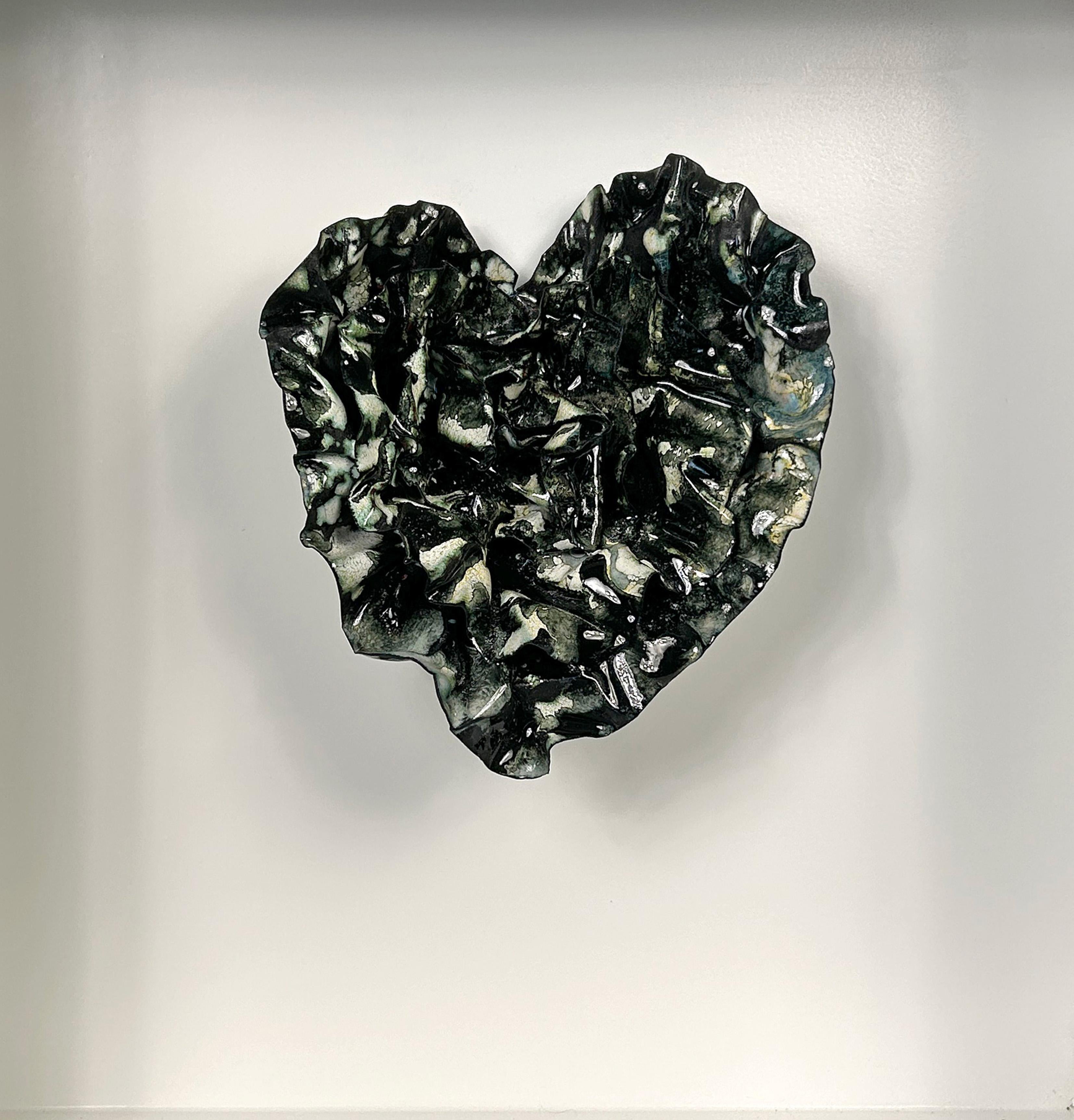 Black Tapestry is a heart shaped enameled sculpture that captivates with its intricate patterns and textures, reminiscent of a richly woven abstract tapestry.
Black Tapestry is an evolution of patterns that swirl with different textures and patterns