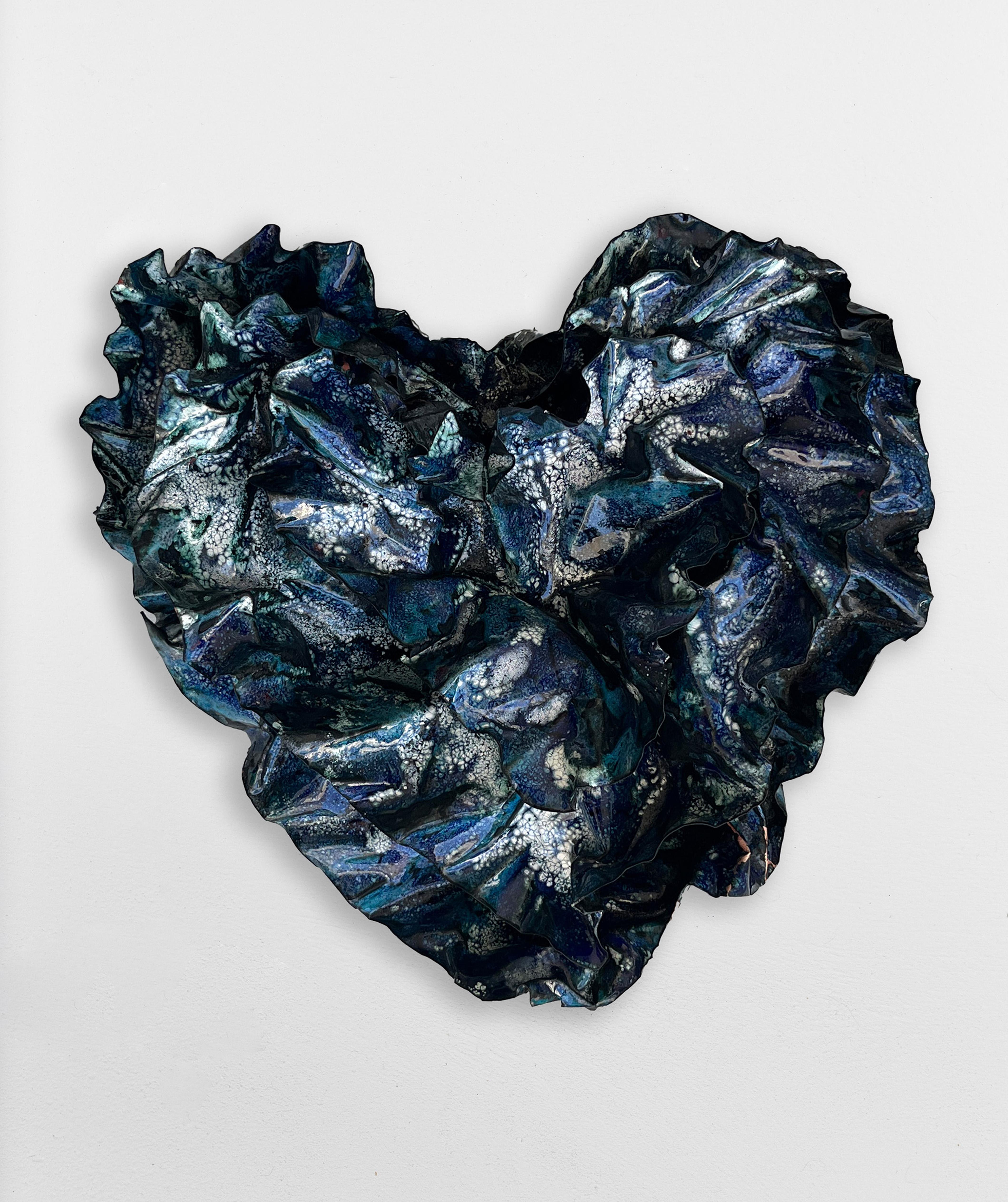 
Many coats of blue on blue with white burning through from the bottom layers, create a visual impact of distance.   Wisps of black strings of glass were fired as each layer of glass was added to the sculpture.   The sculpture was heated to 1600