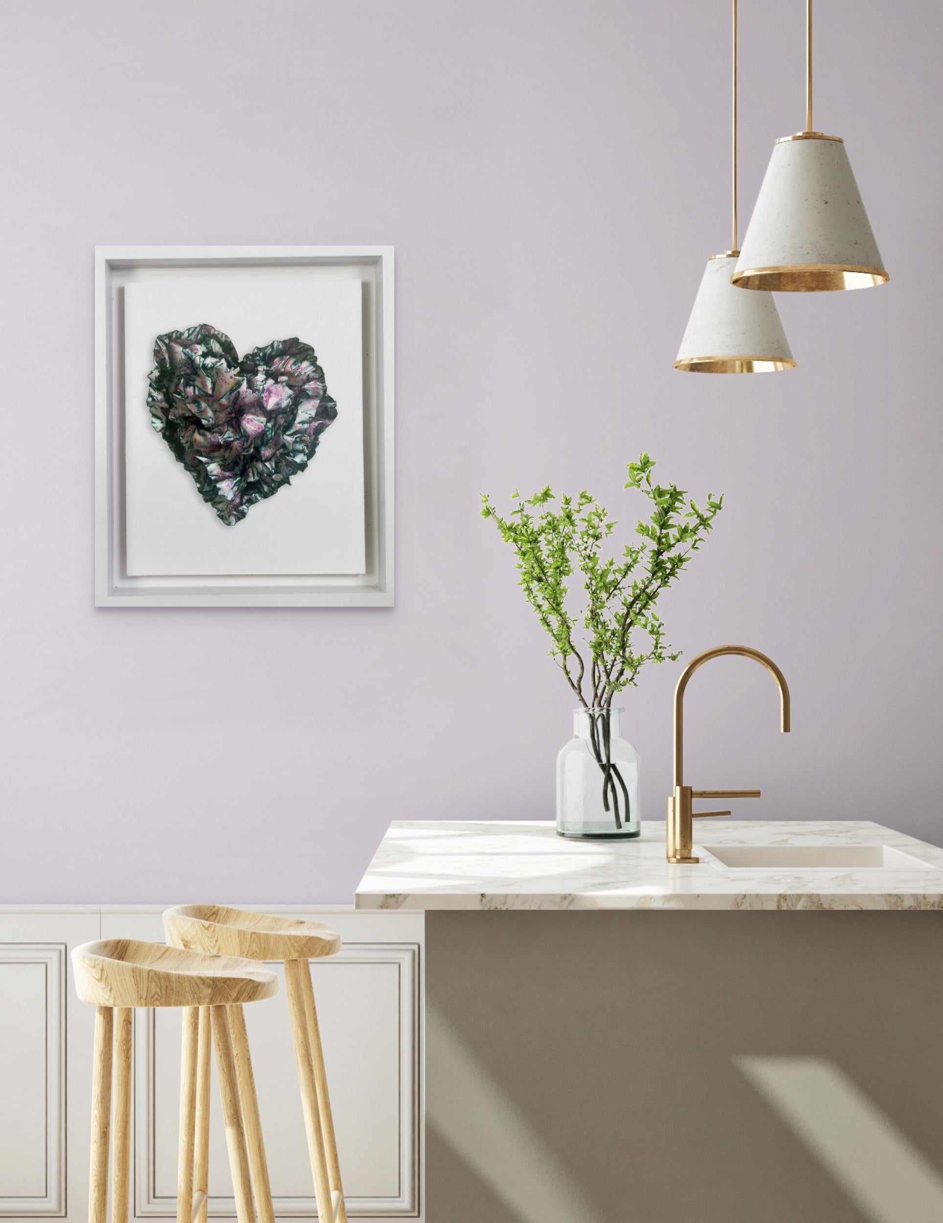This heart shaped sculpture is layered in a playful purple with hints of yellow and rich orange lightly scattered throughout the sculpture.    The initial layers of white help bring a brightness to the colors, showcasing the purples where the colors