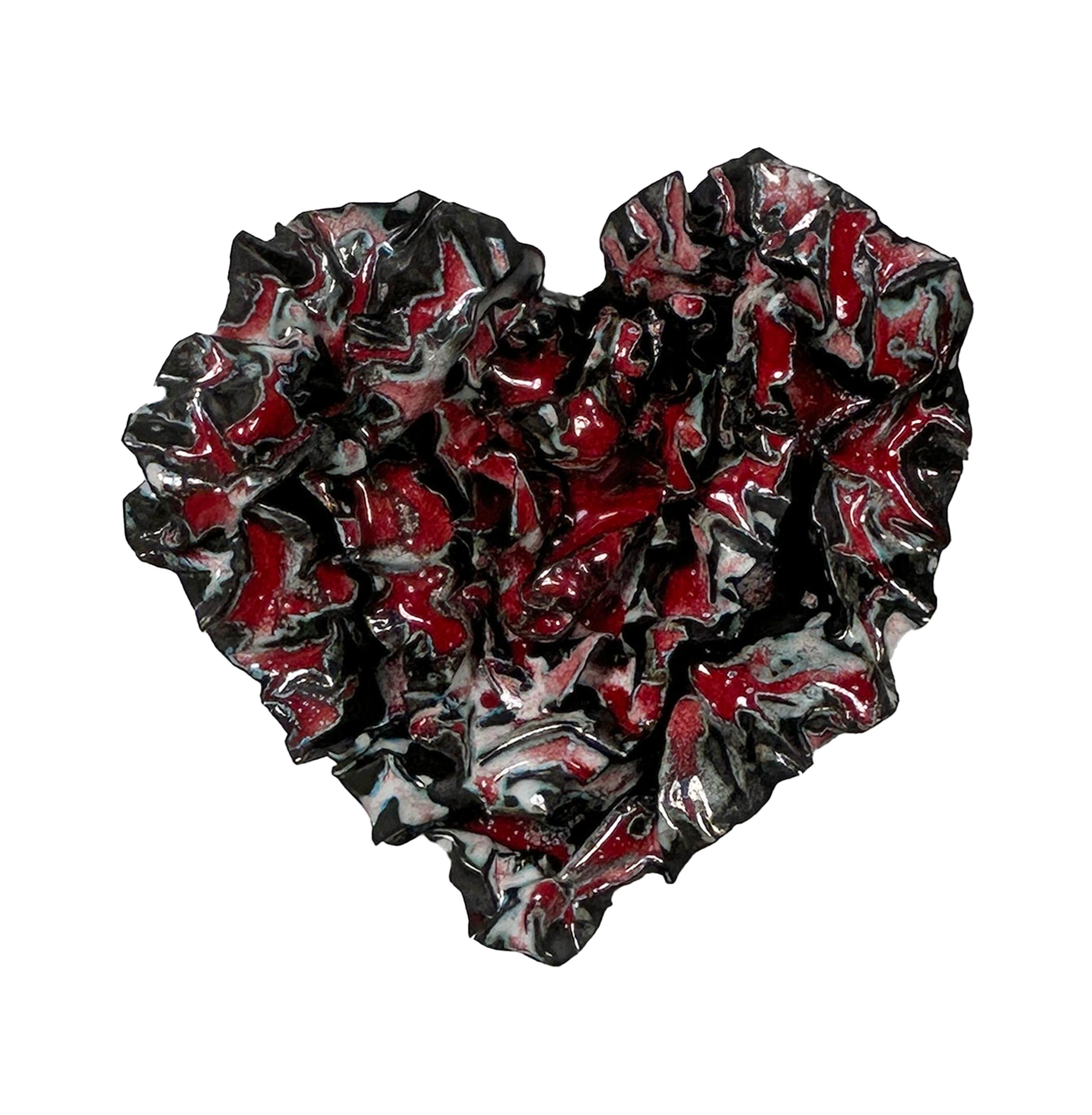 Ribbons of Red, is an abstract heart enameled sculpture that pulsates with vibrant energy and dynamic hues. This striking piece features a captivating interplay of red, black, and white, with red commanding attention as the dominant color, swirling