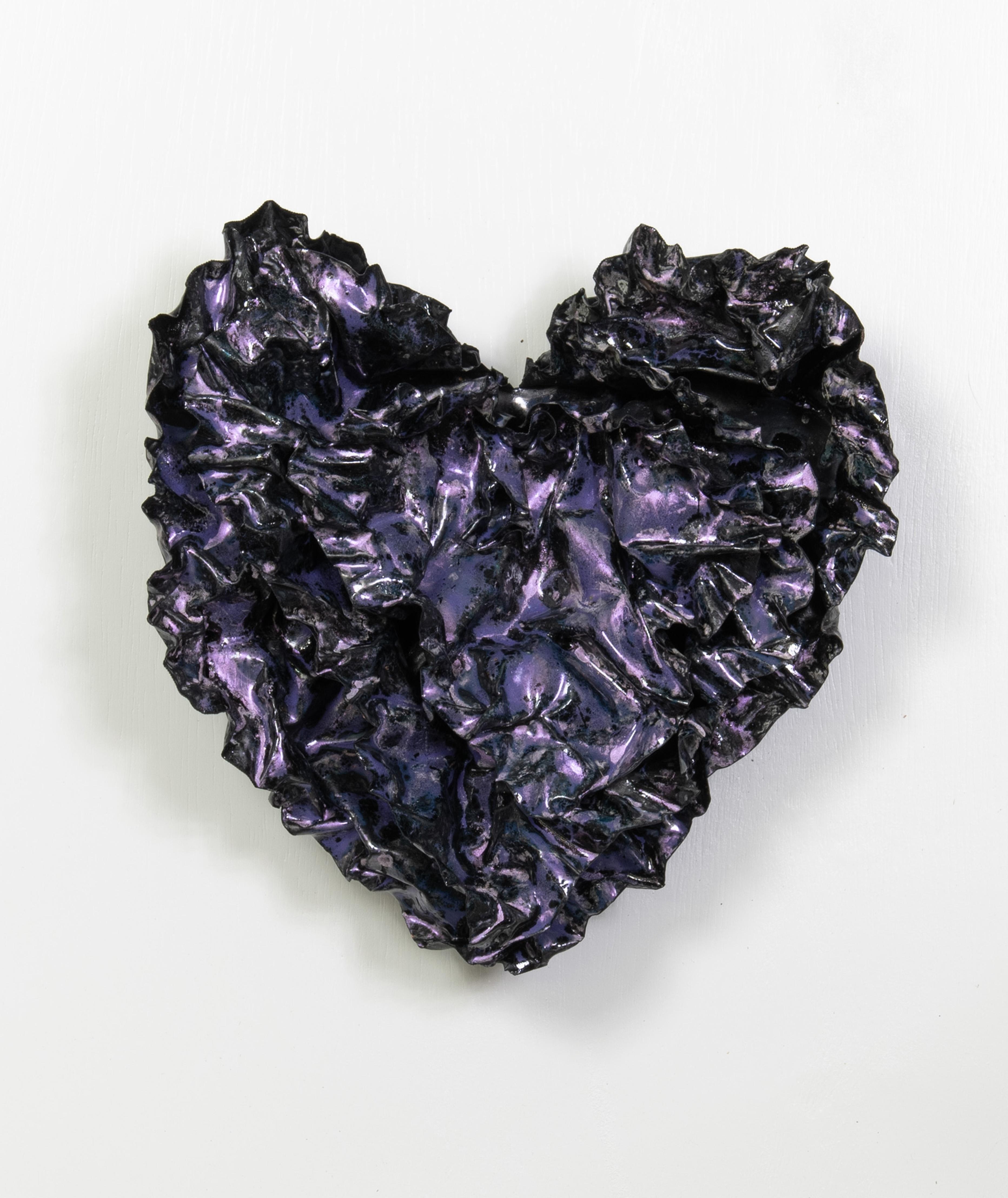 The final luminescent coat of this shimmering heart was fired very briefly at a lower temperature, allowing the luminescent finish to sit on top of the purple base and create a lustrous finish to the sculpture.