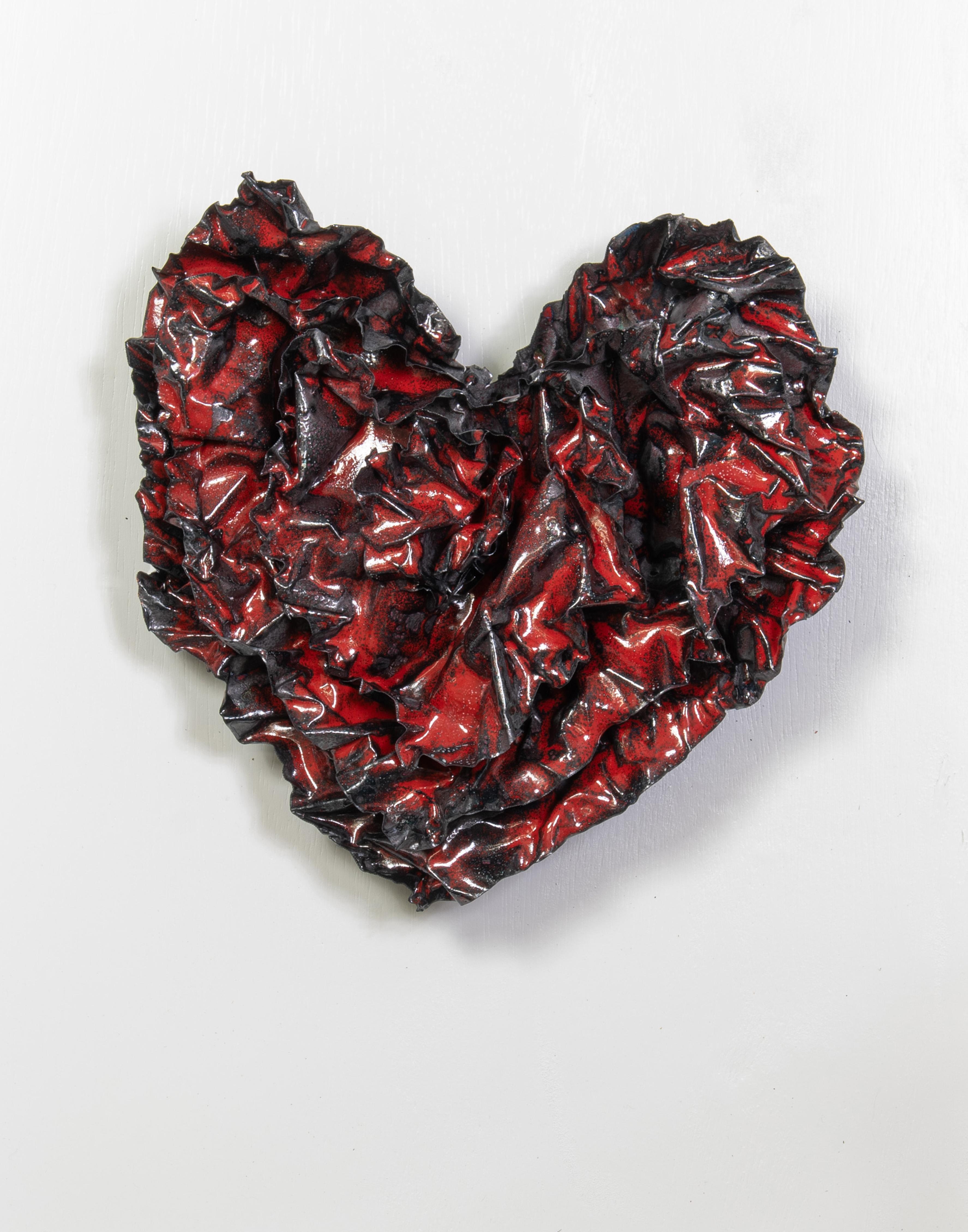 This crimson red heart is equally mixed with black glass to create a sultry sexual energy.  The heart was fired at a lower temperature to allow the black background to have a roughness juxtaposed against the red glass on the surface.  The sculpture