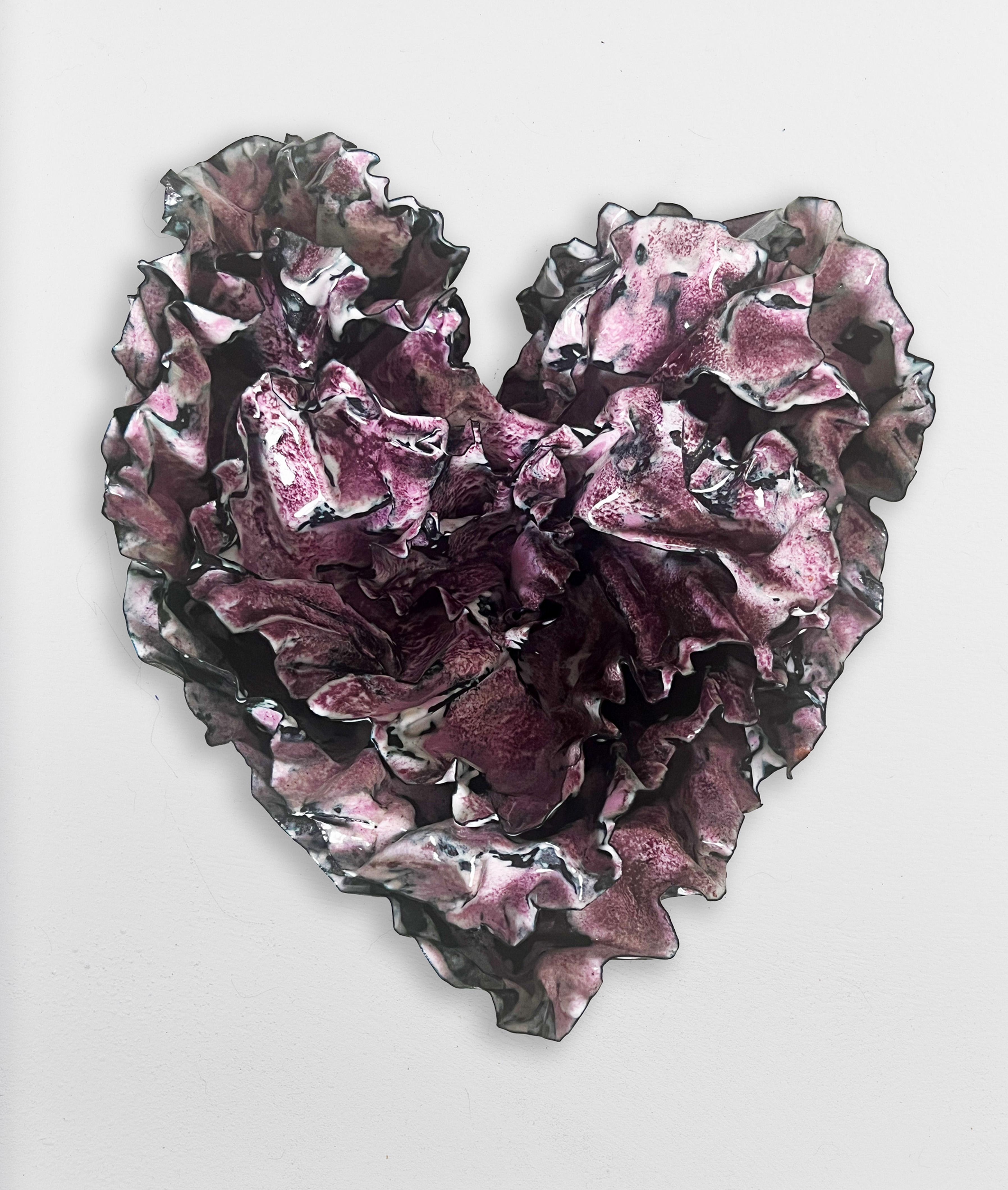 The richness of color on this heart is so deep that it feels like a purple.  It was created with a white base and the purples and pinks were fired in one firing, allowing the colors to merge into hues of rich colors.  The pink is very saturated with