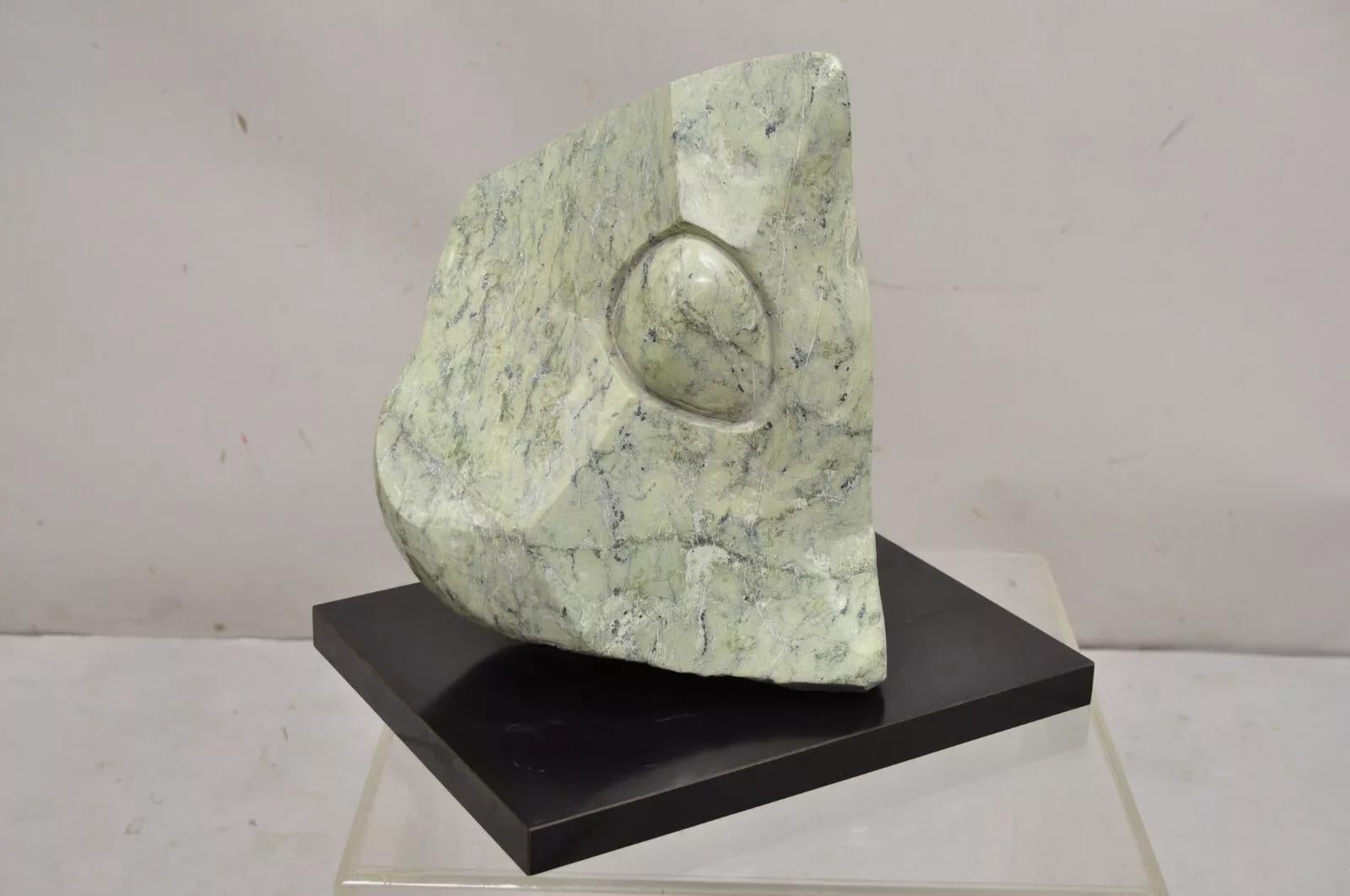 Sheryl Cannold Benjamin (American, 1924 - 2023) Carved Green Marble Abstract Modern Stone Sculpture on Laminated Pedestal. Circa Late 20th Century. Measurements: 14