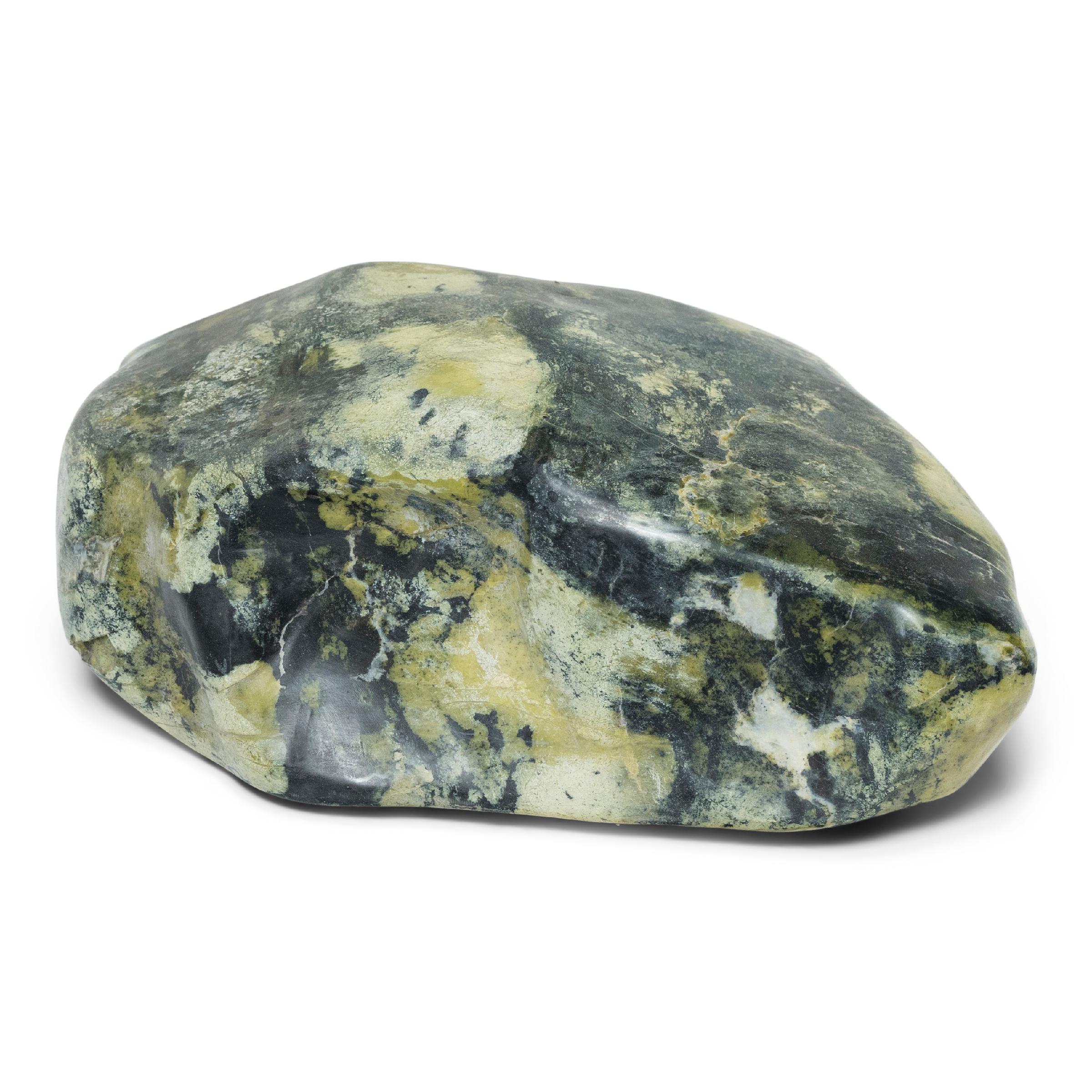 Following the sculpted form, marbled coloring, and natural veining of this one-of-a-kind stone can be deeply meditative. Viewed as a source of beauty and creativity, Chinese scholar-artists would decorate their studios and gardens with similar